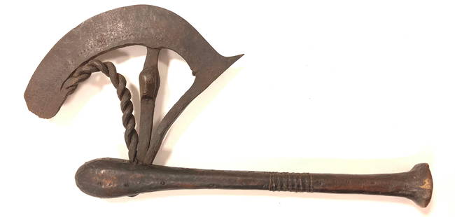 African traditional axe "Nzappa zap" (or "kilonda"). The Songe tribe. An ornate wrought iron blade: African traditional axe "Nzappa zap" (or "kilonda"). The Songe tribe. An ornate wrought iron blade connected to a club-like wooden hilt covered with a chased metal plate. The weapon, originally from t