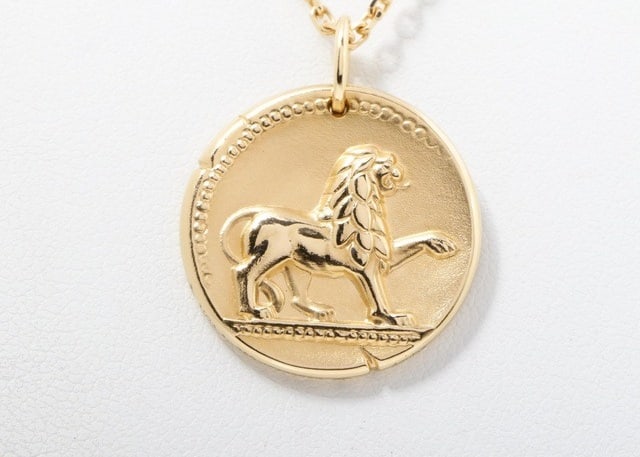 Van Cleef & Arpels Zodiac Leo Lion 18K Yellow Gold Pendant Necklace: Title/Medium: Van Cleef & Arpels Zodiac Leo Lion Pendant Necklace in 18K Yellow Gold Origin/Year: Van Cleef & Arpels, Circa Contemporary Dimensions: Coin-shaped pendant, substantial in width Condition