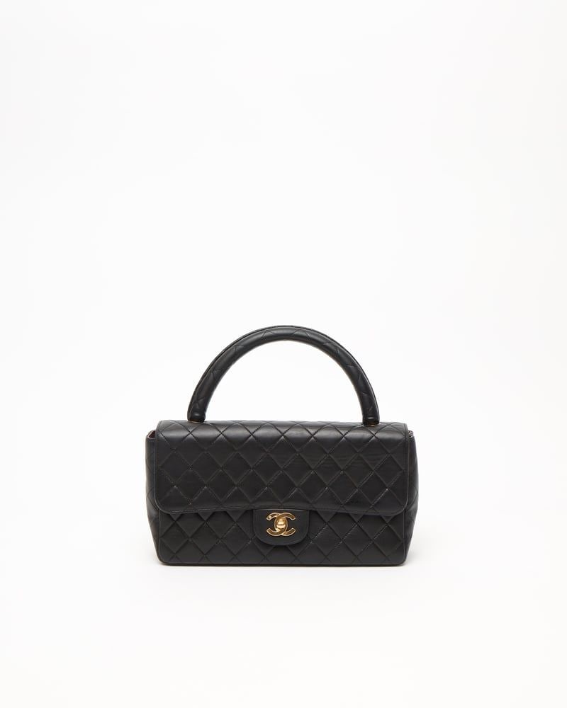 Chanel Classic Kelly Top Handle Bag - Vintage: Title: Chanel Classic Kelly Top Handle Bag Medium: Quilted Leather, Gold-tone Hardware Origin/Year: Made in France, 1994-1996 Dimensions:Height: 15 cmWidth: 26 cmDepth: 7 cmHandle drop: 11