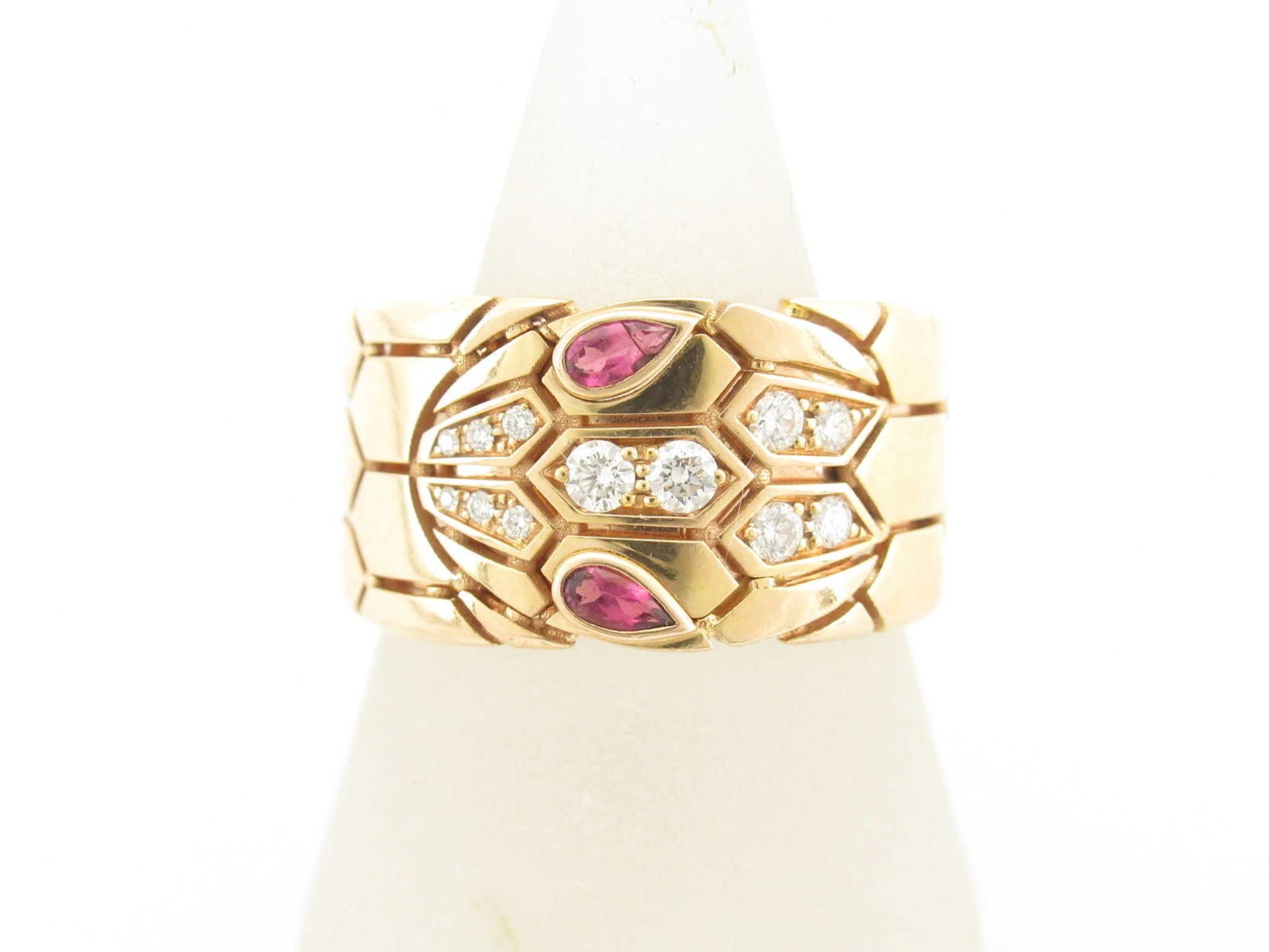 Bulgari Serpenti Viper Snake Pink Tourmaline Eyes 18K Rose Gold Wide Band Ring: This striking Bulgari Serpenti Viper wide band ring is crafted in solid 18K gold and features the iconic snake motif, accented with vivid pink tourmaline gemstones forming the serpent's eyes. The bold