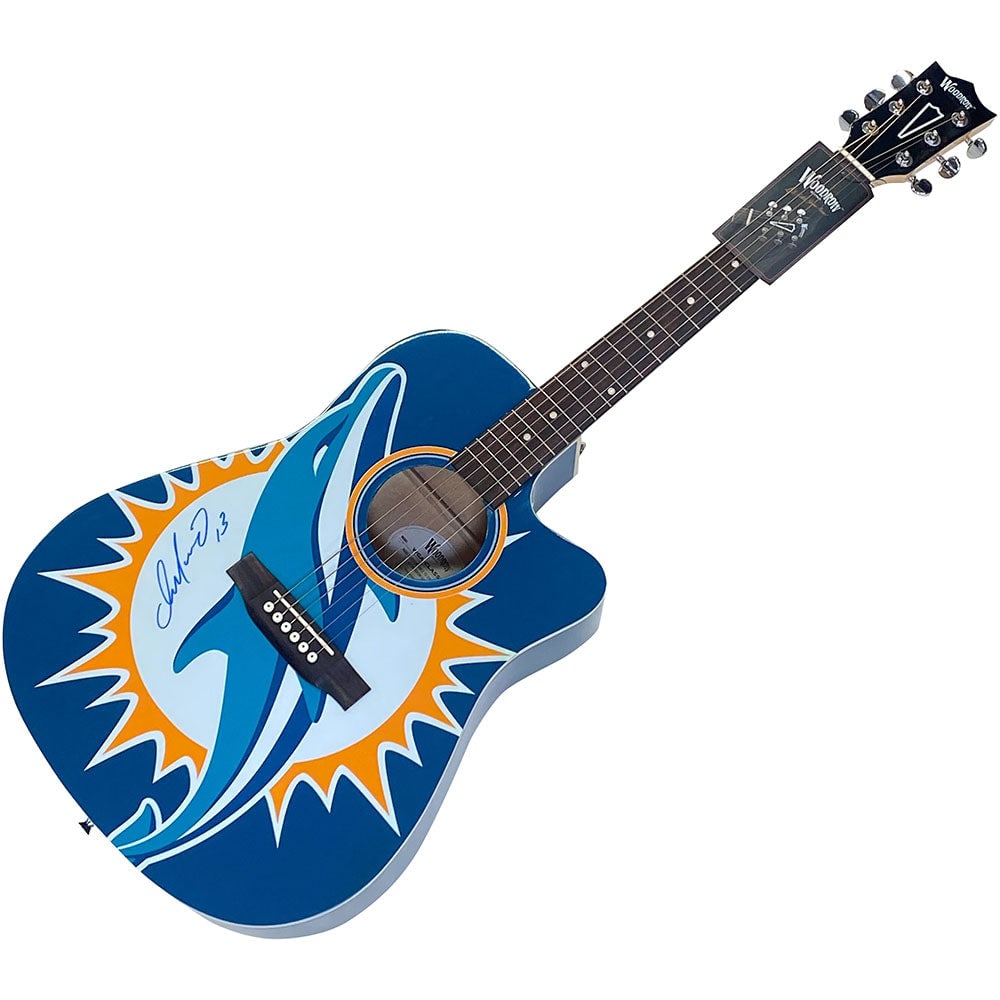 Dan Marino Autographed Miami Dolphins Woodrow Acoustic Guitar: Title/Medium: Dan Marino Autographed Miami Dolphins Woodrow Acoustic Guitar Get your very own Miami Dolphins Woodrow acoustic guitar that has been autographed by legendary Hall of Fame quarterback ? D