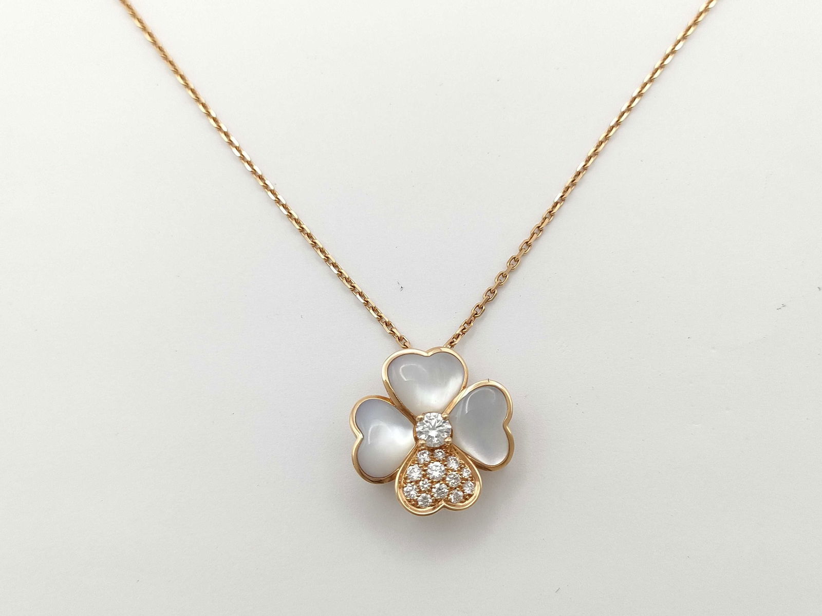 Van Cleef & Arpels Cosmos White MOP & Diamonds 18K Rose Gold Brooch Pendant Necklace: This elegant Van Cleef & Arpels Cosmos brooch pendant necklace is crafted in solid 18K gold and features the iconic floral motif, set with luminous white mother of pearl petals accented by brilliant d