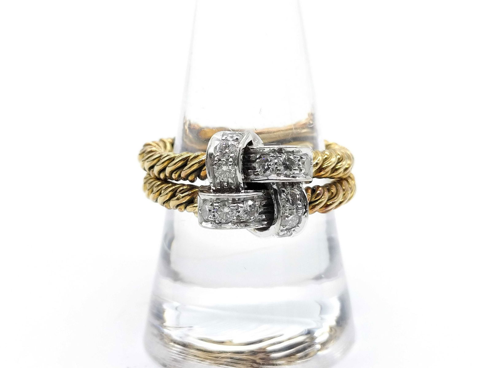 Diamond 18K Yellow Gold Knot Ring: Elegant Pomellato diamond ring crafted in solid 18K yellow gold, featuring a sculptural knot-style design accented with pave-set diamonds. The twisted gold band elements create a bold dimensional look