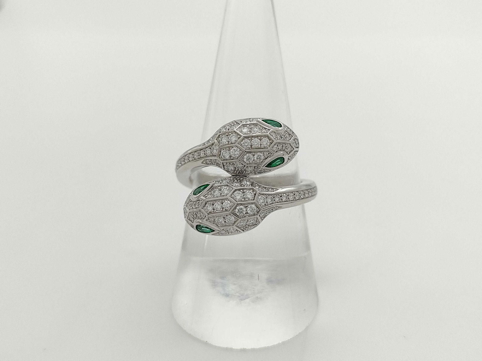Bulgari Serpenti Viper Snake Double Head Emerald & Diamond Pave 18K White Gold Ring: This exceptional Bulgari Serpenti Viper ring is crafted in solid 18K gold and features the iconic double snake head motif, set with vivid emerald gemstones that display rich color and striking contras