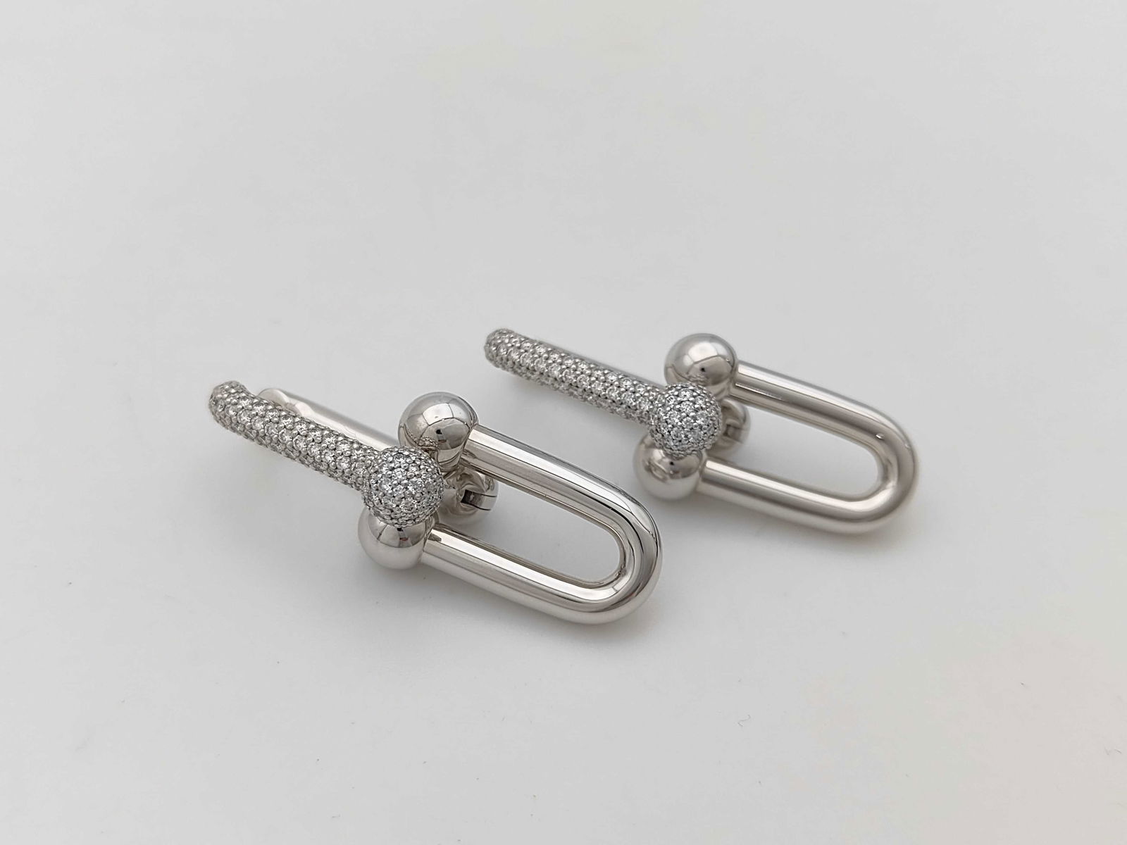 Tiffany & Co. HardWear Large Link Diamond Pave 18K White Gold Earrings: Striking Tiffany & Co. HardWear Large Link earrings crafted in solid 18K white gold and accented with pave-set diamonds. The bold industrial-inspired link design is enhanced with diamond pave detailin
