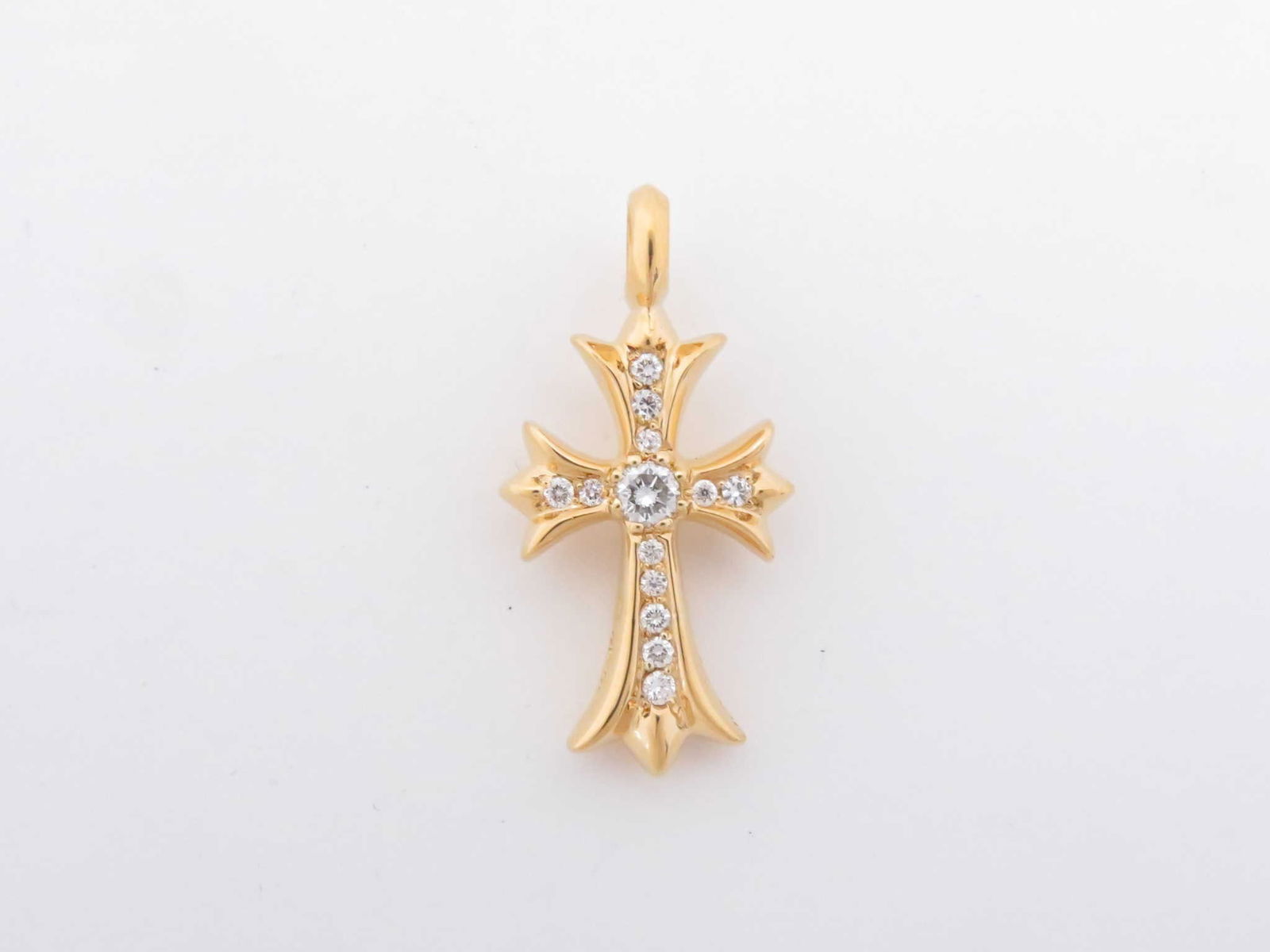 Chrome Hearts Tiny Fat Cross Diamond Gold Pendant: Description: Iconic Chrome Hearts Tiny Fat Cross pendant top crafted in solid gold, featuring the brand?s bold gothic cross silhouette accented with brilliant diamonds throughout. The thicker profile