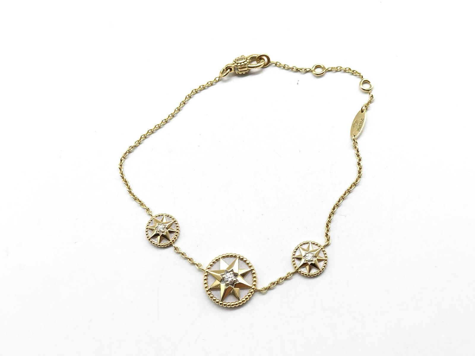 Dior Rose des Vents 3 Motif Diamond Mother of Pearl 18K Yellow Gold Bracelet: Elegant Dior Rose des Vents bracelet crafted in 18K yellow gold featuring a rare three motif design from the iconic collection. The bracelet showcases three compass rose medallions set with luminous m