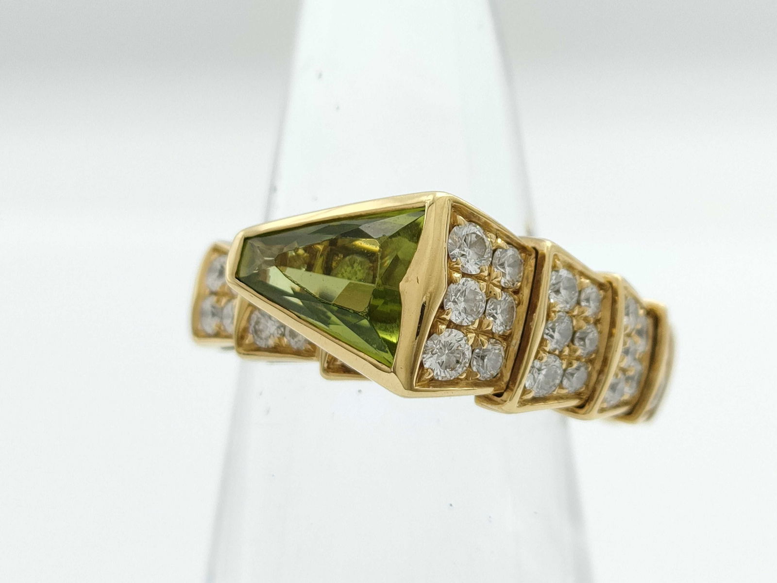 Bulgari Serpenti Green Peridot & Diamond Pave Snake 18K Yellow Gold Ring: Description: This striking Bulgari Serpenti ring is crafted in solid 18K gold and features the iconic snake motif, set with a single uniquely cut green peridot that displays exceptional color, brillia
