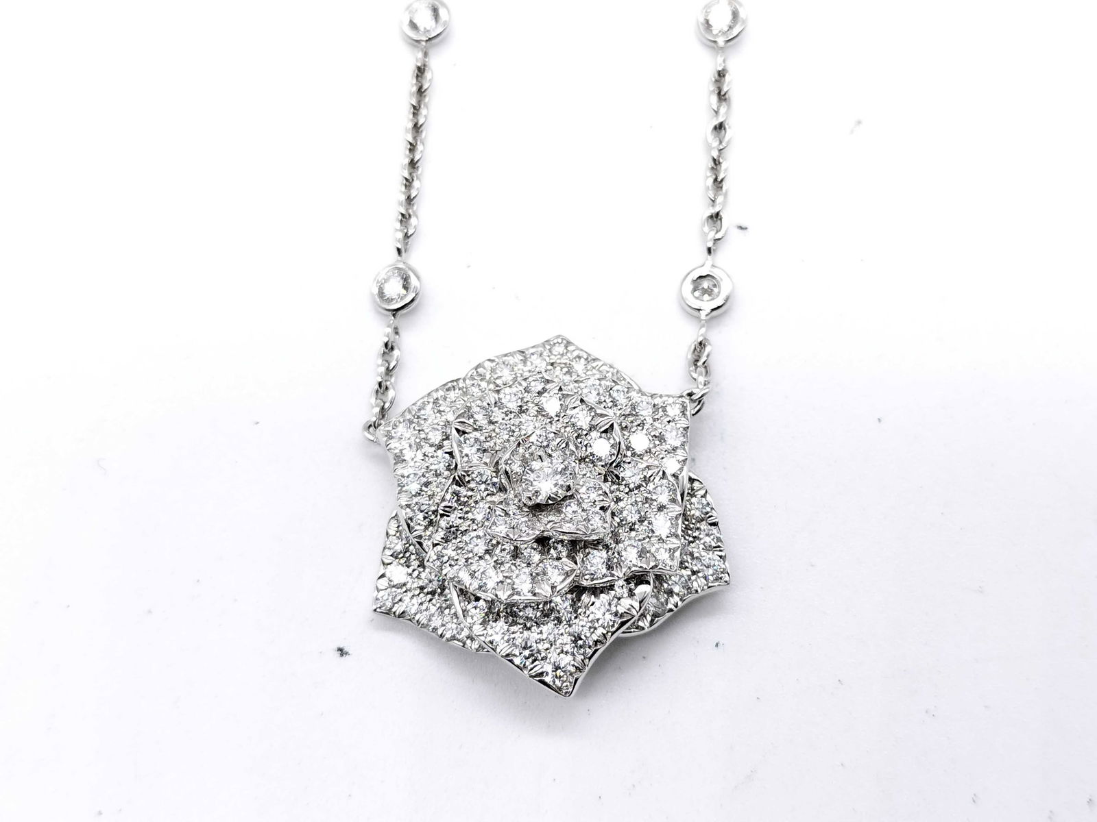 Piaget Large Rose Diamond 18K White Gold Pendant Necklace: Elegant Piaget pendant necklace crafted in solid 18K white gold featuring a sculptural rose motif set with numerous brilliant diamonds. The dimensional floral design reflects Piaget’s refined artist