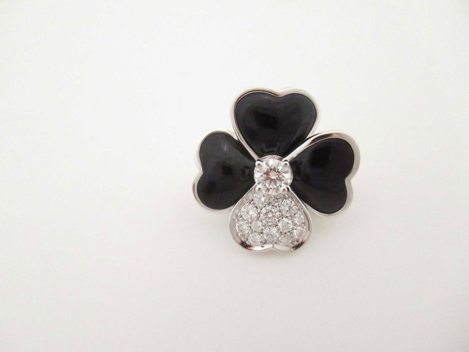 Van Cleef & Arpels Cosmos Black Onyx & Diamond 18K White Gold Brooch: Description: This elegant Van Cleef & Arpels Cosmos brooch is crafted in solid 18K gold and features the iconic floral motif, set with richly colored black onyx petals accented by brilliant diamonds.