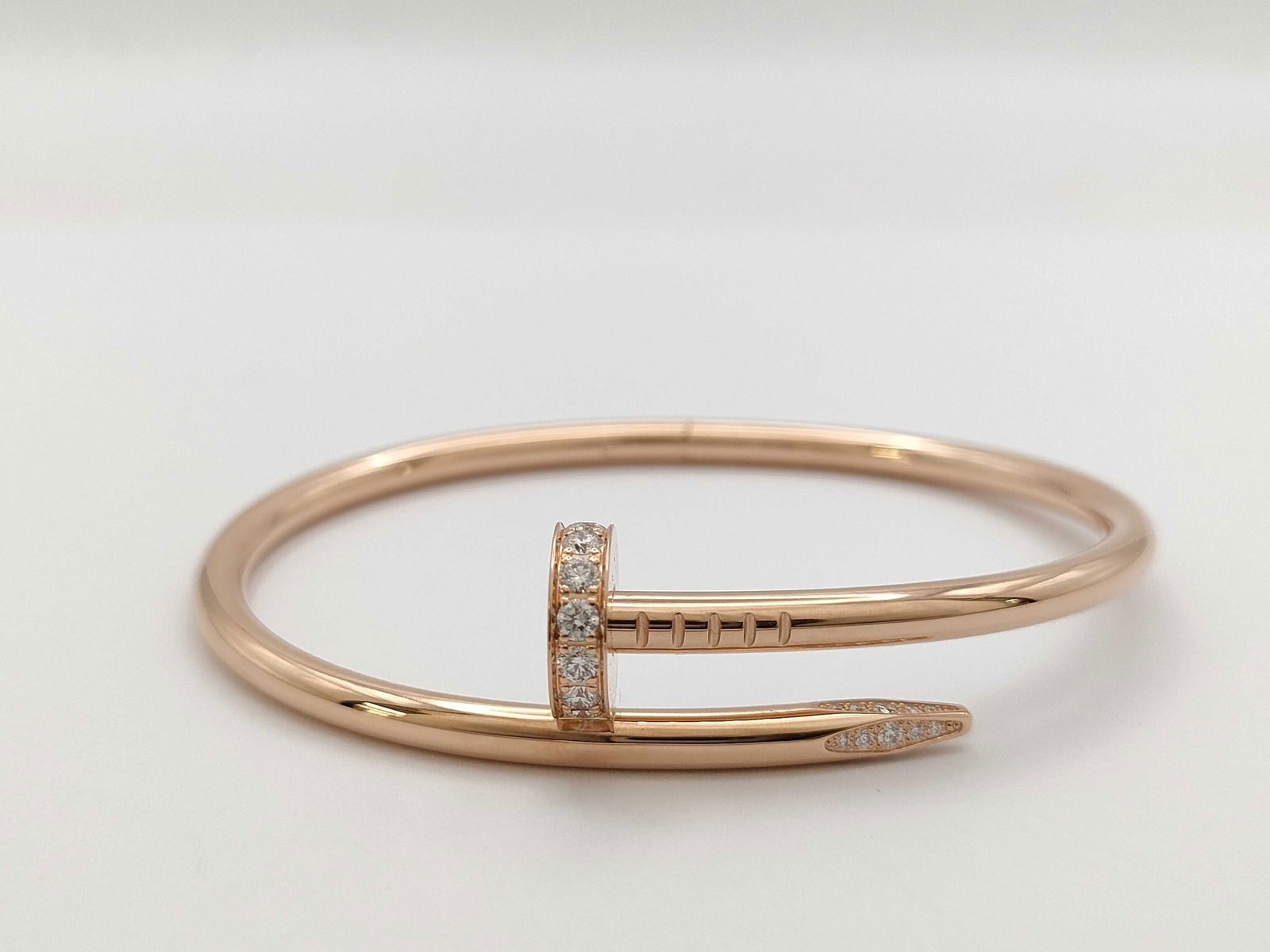 Cartier Juste Un Clou Nail Diamond Pave 18K Rose Gold Bangle Bracelet: Description: This iconic Cartier Juste un Clou bangle bracelet is crafted in solid 18K gold and features the signature nail motif, fully set with brilliant pave diamonds that create exceptional brilli