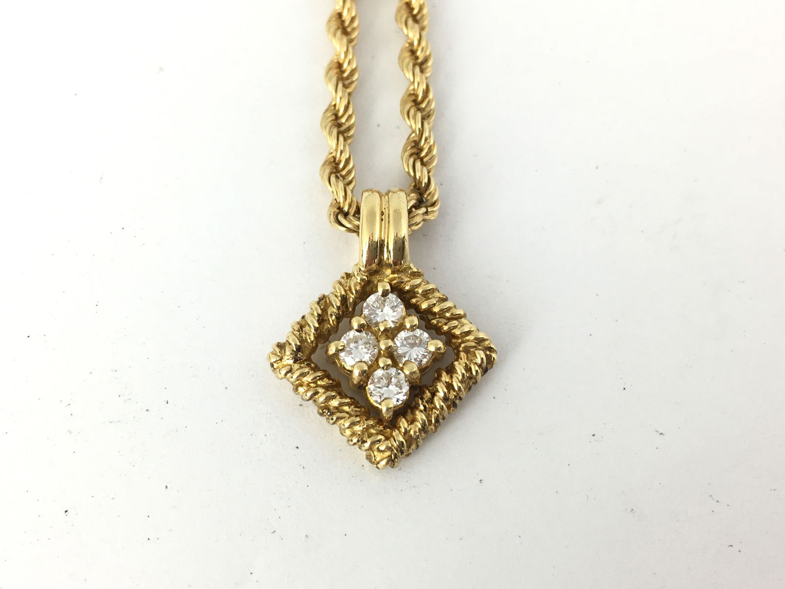 Vintage Estate Diamond 18K Yellow Gold Pendant Necklace: Description: This refined Boucheron necklace is crafted in solid 18K yellow gold and features a sculptural diamond-set pendant suspended from an elegant textured gold chain. The design reflects the Ma