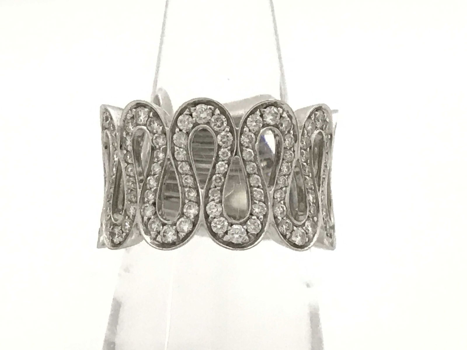 Vintage Spiral Wave Diamond 18K White Gold Ring: This elegant Ellison ring is crafted in solid 18K white gold and features brilliant pavé-set diamonds in a bold, sculptural repeating motif design. The distinctive open oval pattern reflects refined