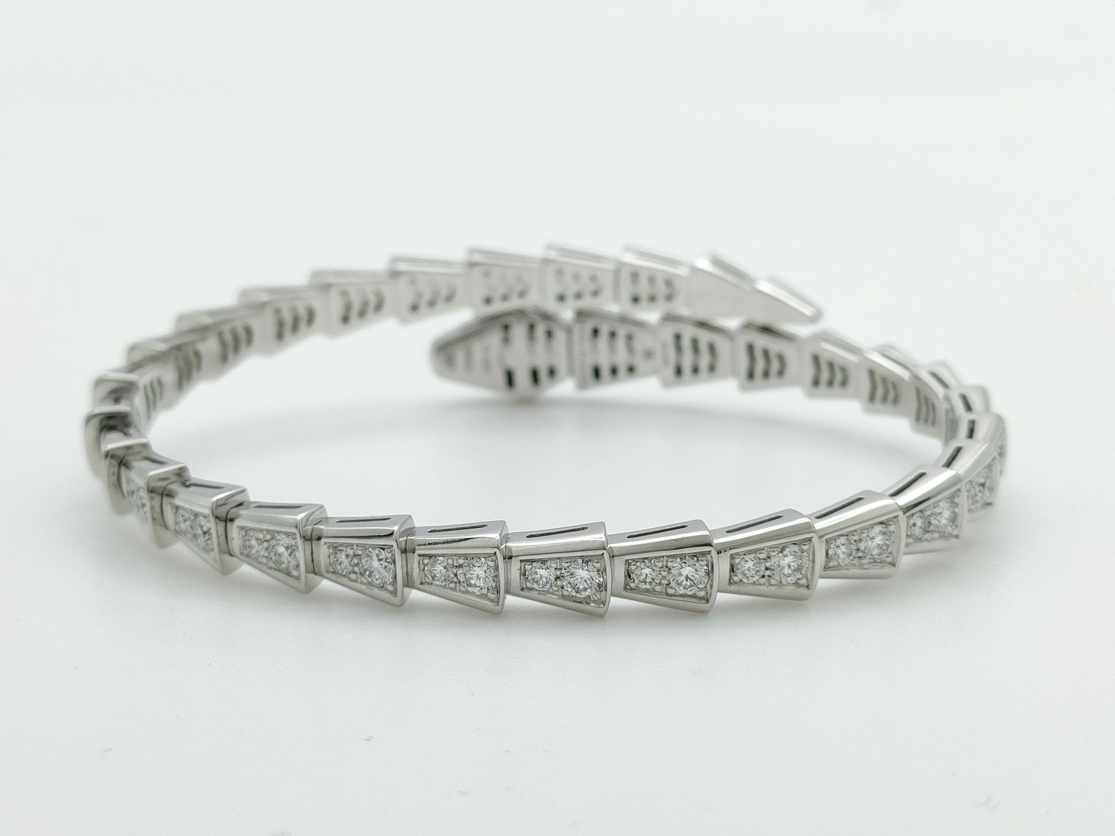 Bulgari Serpenti Viper Snake Diamond 18K White Gold Bracelet Bangle: This refined Bulgari Serpenti Viper bangle bracelet is crafted in solid 18K gold and features the iconic serpent motif, set with brilliant pavé-set diamonds that create exceptional brilliance and ele