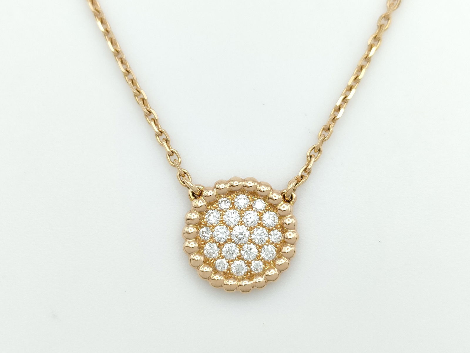 Van Cleef & Arpels Perlee Diamond 18K Gold Pendant Necklace: This elegant Van Cleef & Arpels Perlee pendant necklace is crafted in solid 18K gold and features brilliant diamonds set within the collection’s signature beaded gold design. The refined pendant for