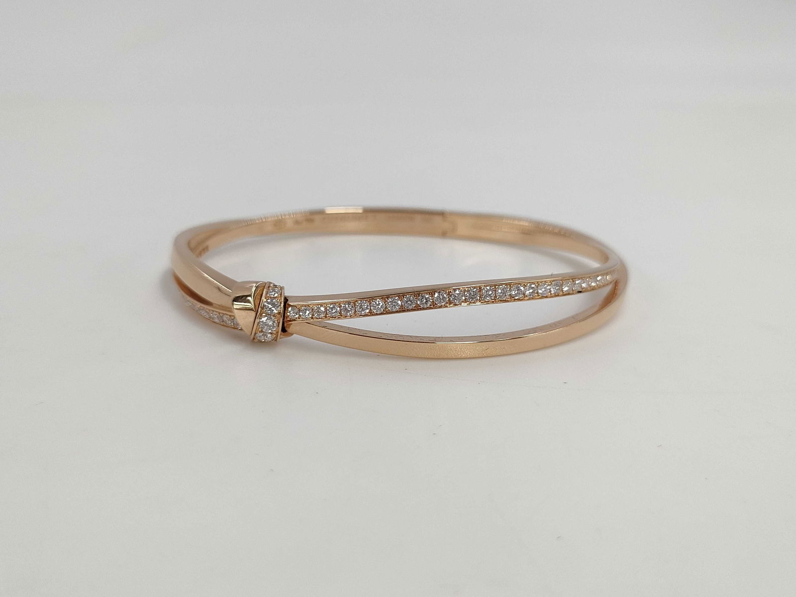 Chaumet Seduction Diamond 18K Rose Gold Ribbon Bangle Bracelet: This elegant Chaumet Seduction bracelet bangle is crafted in solid 18K rose gold and features brilliant diamonds set within the Maison’s refined and contemporary crossover design. The graceful form