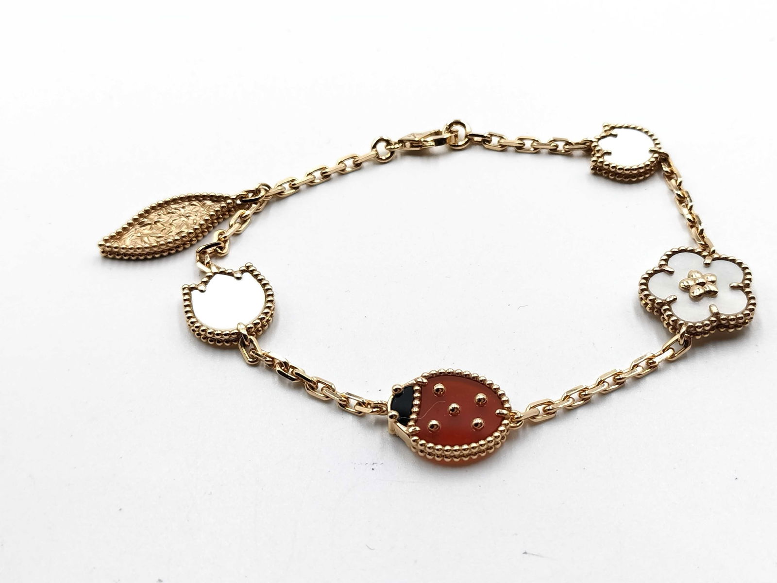 Van Cleef and Arpels Lucky Alhambra Multi Motif 18K Rose Gold Bracelet: Elegant Van Cleef & Arpels Lucky Alhambra bracelet crafted in 18K rose gold, showcasing a delightful harmony of iconic and whimsical motifs. The composition features luminous mother-of-pearl clover, a