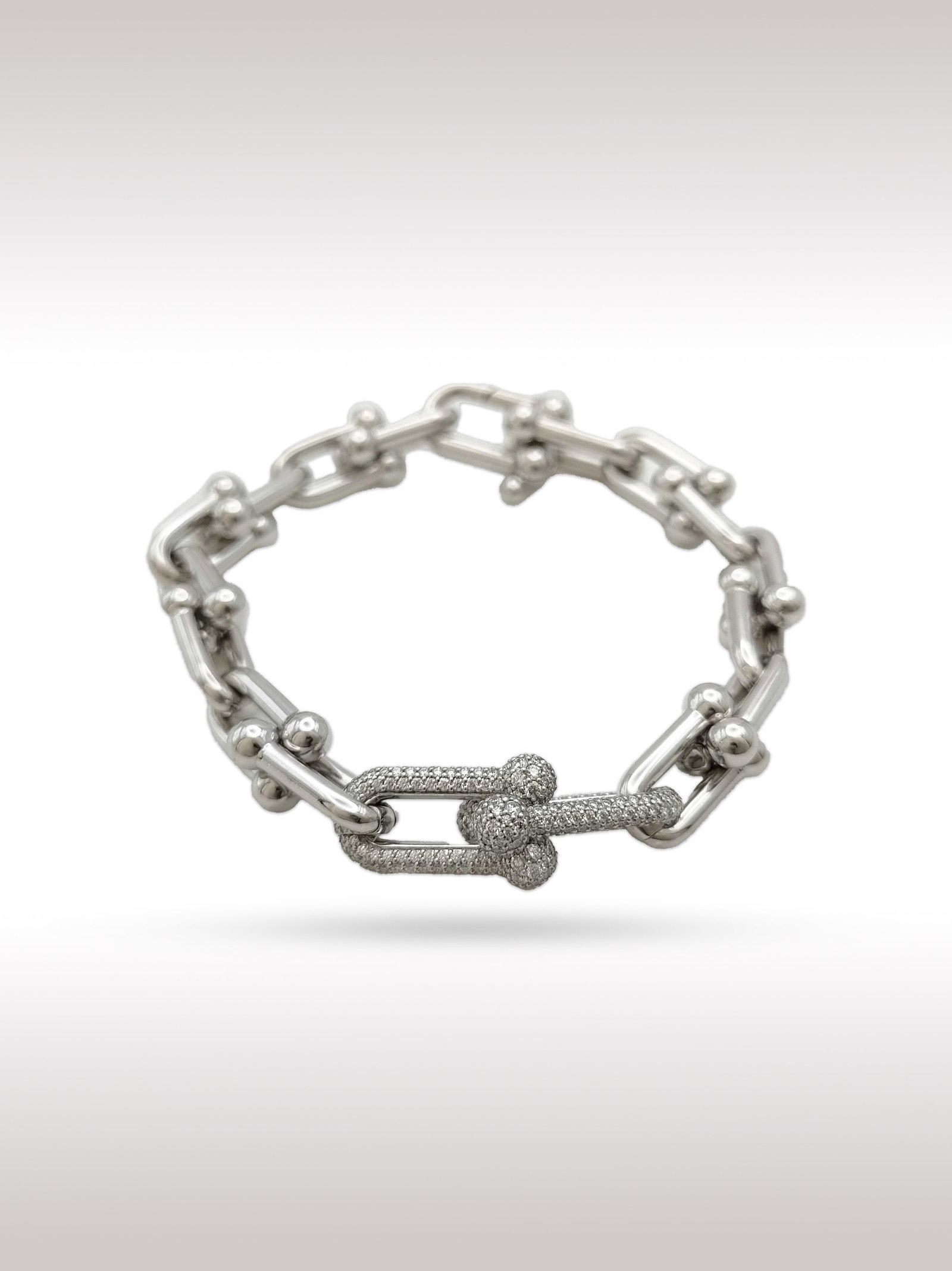 Tiffany & Co. HardWear Medium Link Diamond Pave 18K White Gold Bracelet: Description: Elegant Tiffany Co HardWear bracelet crafted in 18K white gold, featuring the iconic medium link design with select links fully set with pave diamonds. The bold industrial inspired silhou