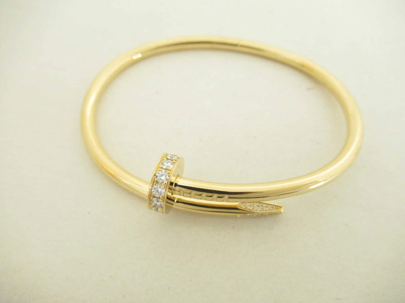 Cartier Juste Un Clou Diamond Pave 18K Yellow Gold Bracelet Bangle Size 17: Iconic Cartier Juste Un Clou bracelet crafted in 18K yellow gold, designed in the form of a stylized nail wrapped elegantly around the wrist. The head and tip are accented with brilliant cut diamonds,