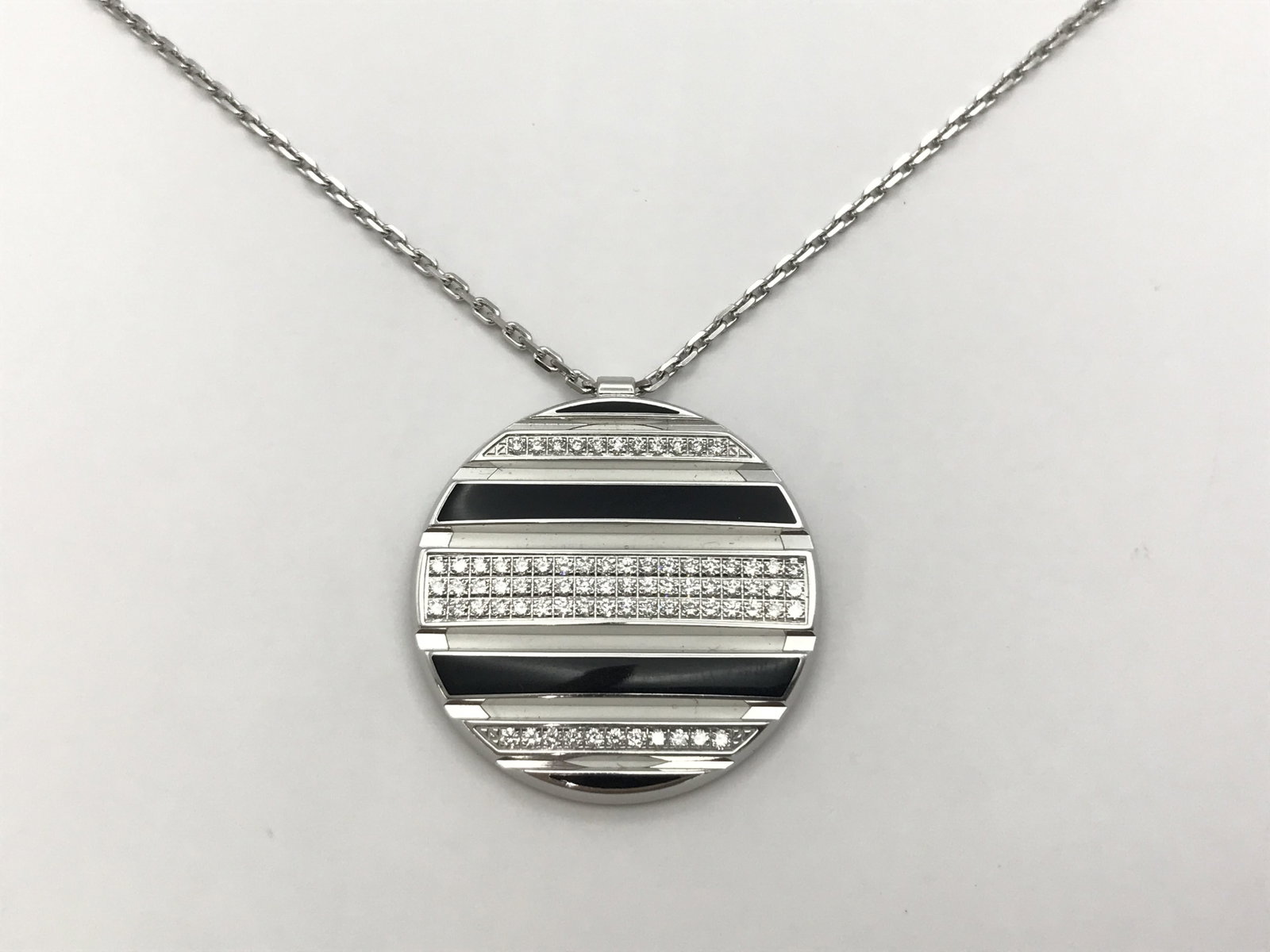 Chaumet Class One Diamond Onyx 18K White Gold Pendant Necklace: Description: This elegant Chaumet Class One necklace is crafted in solid 18K white gold and features brilliant diamond accents combined with striking black onyx in a bold geometric pendant design. The