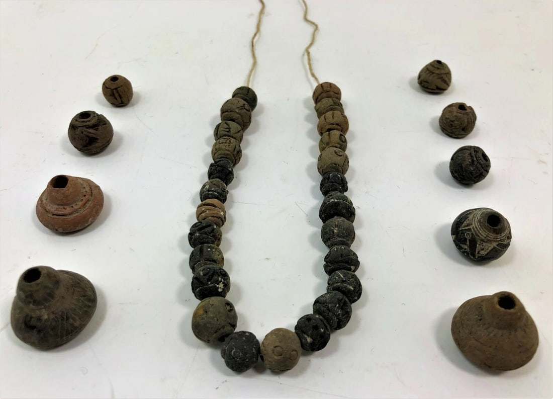 Ancient Near Eastern/Egyptian Clay Necklace: Title/Medium: Near Eastern/Egyptian Ceramic Necklace Origin/Year: Ancient Near East or Egypt Dimensions: Varies per bead, necklace length approximately X inches Condition: Excellent, with minor signs 
