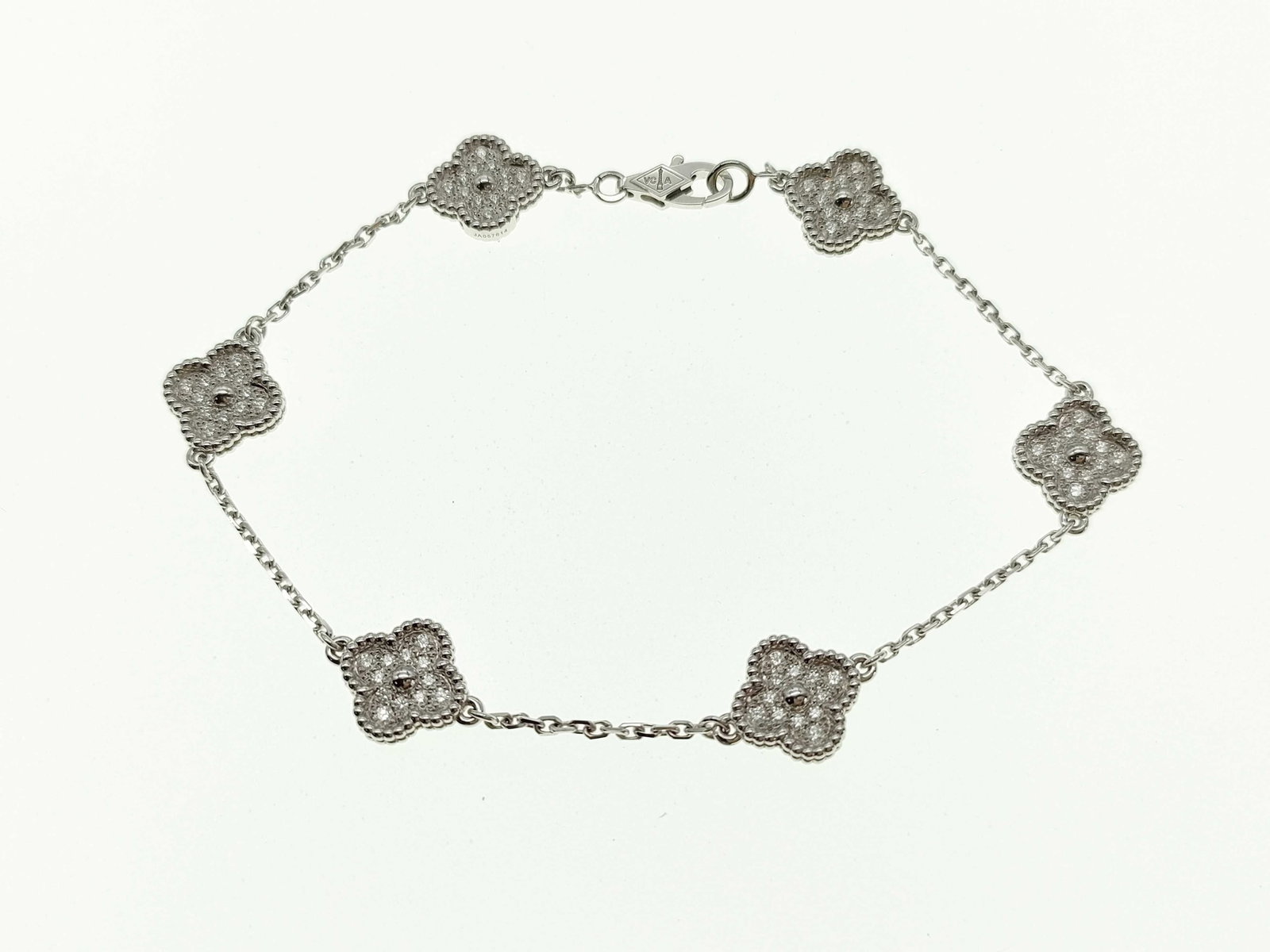 Van Cleef & Arpels Sweet Alhambra 6 Motifs Diamond 18K White Gold Bracelet: Description: Van Cleef & Arpels Sweet Alhambra bracelet crafted in 18K white gold and featuring six iconic Alhambra motifs accented with natural diamonds. Showcasing the Maison's celebrated clover