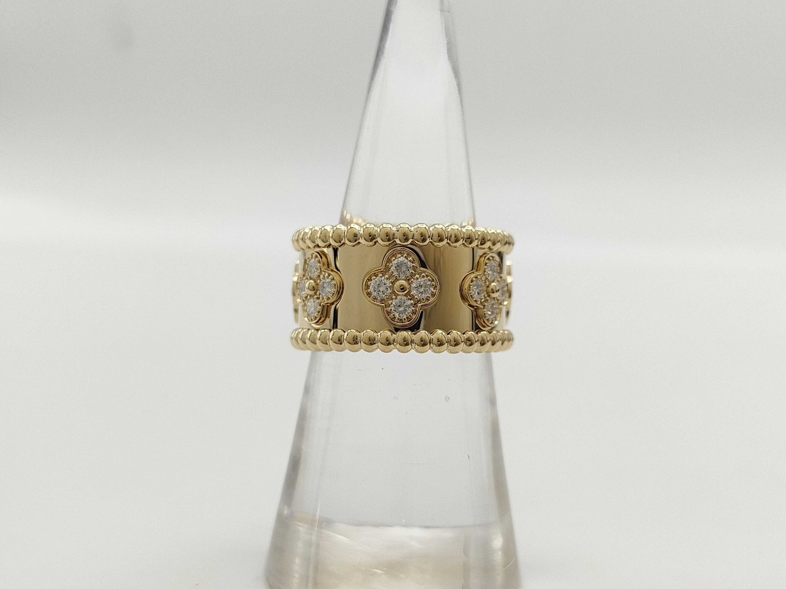 Van Cleef & Arpels Perlee Diamond Clover 18K Yellow Gold Ring: Description: This elegant Van Cleef & Arpels Perlee Clover ring is crafted in solid 18K gold and features the signature clover motif accented with brilliant diamonds. The clean, refined design hig