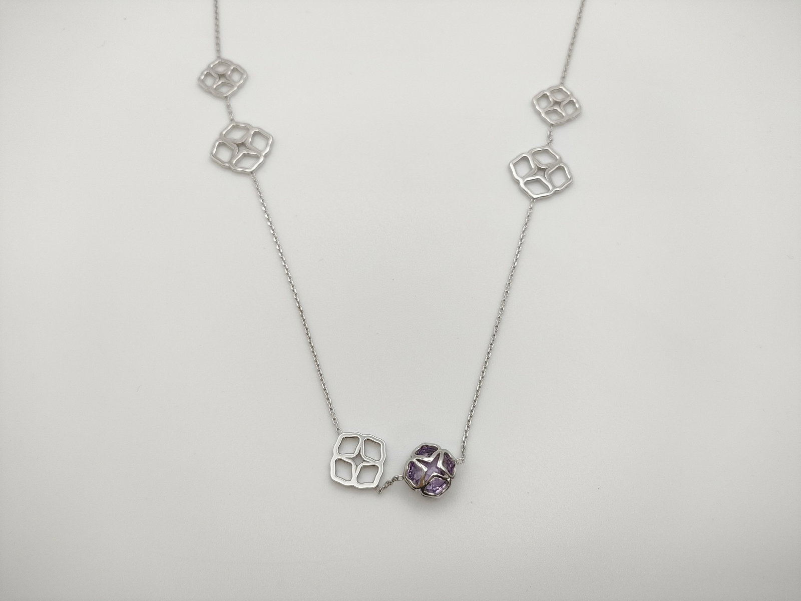 Chopard Imperiale Amethyst 18K White Gold Long Station Necklace: Description: Elegant Chopard Imperiale long necklace crafted in solid 18K white gold, featuring the collection’s distinctive geometric openwork motifs accented with a faceted amethyst element. The r