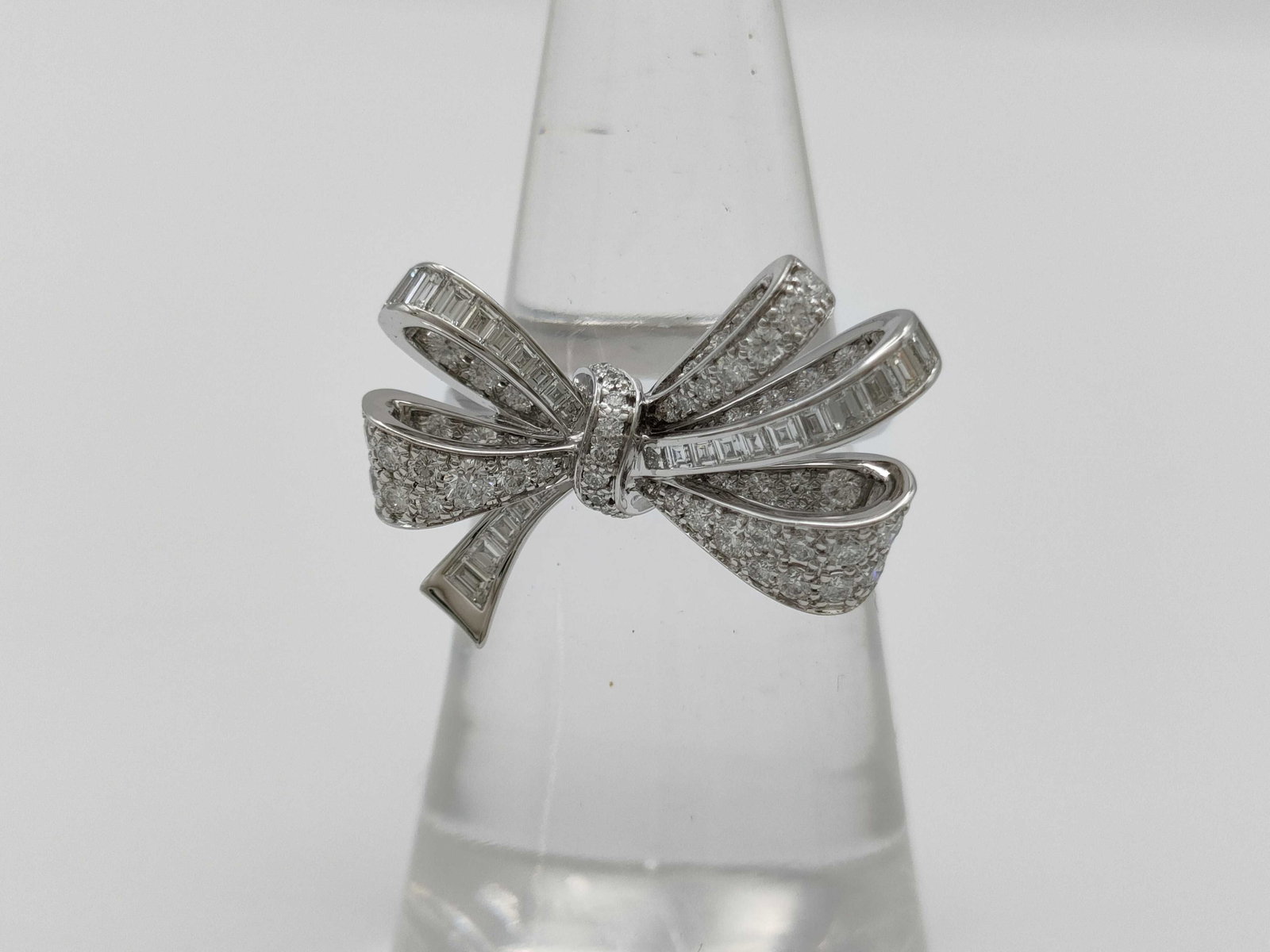 Graff Tildas Bow Diamond 18K White Gold Ring: Description: Elegant Graff Tildas Bow ring crafted in 18K white gold and set with brilliant cut and baguette cut diamonds. The design features Graff's signature bow motif with flowing diamond set ribb