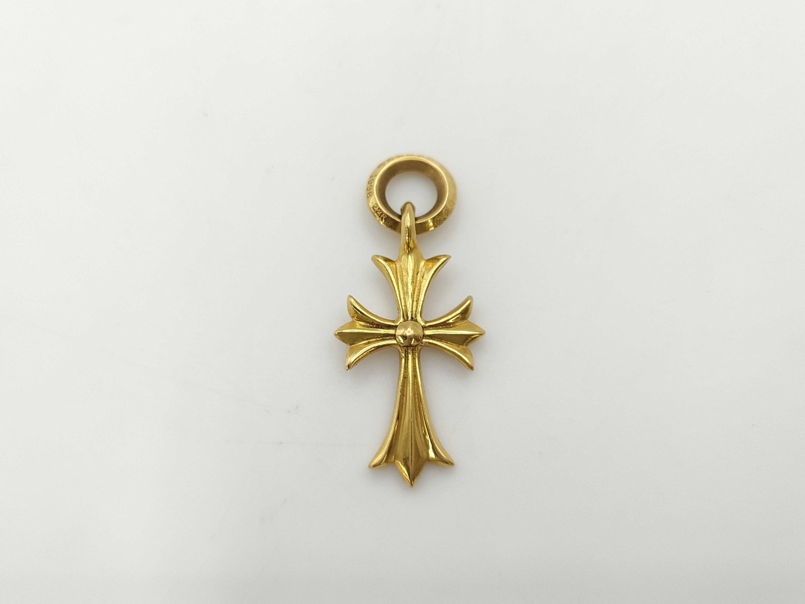 Chrome Hearts Cross 22K Gold Charm Pendant: Description: Iconic Tiny CH cross charm pendant crafted in solid gold, featuring Chrome Hearts’ signature cross silhouette with sculptural contours and bold dimensional form. The refined proport
