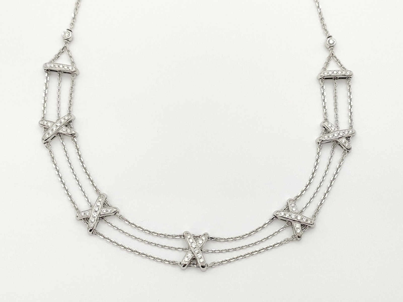 Chaumet Lian Diamond 18K White Gold Multi-Strand Link X Necklace: Description: This elegant Chaumet Lian necklace is crafted in solid 18K white gold and features brilliant diamonds set within the Maison’s iconic intertwined cross motif design. The refined multi-st
