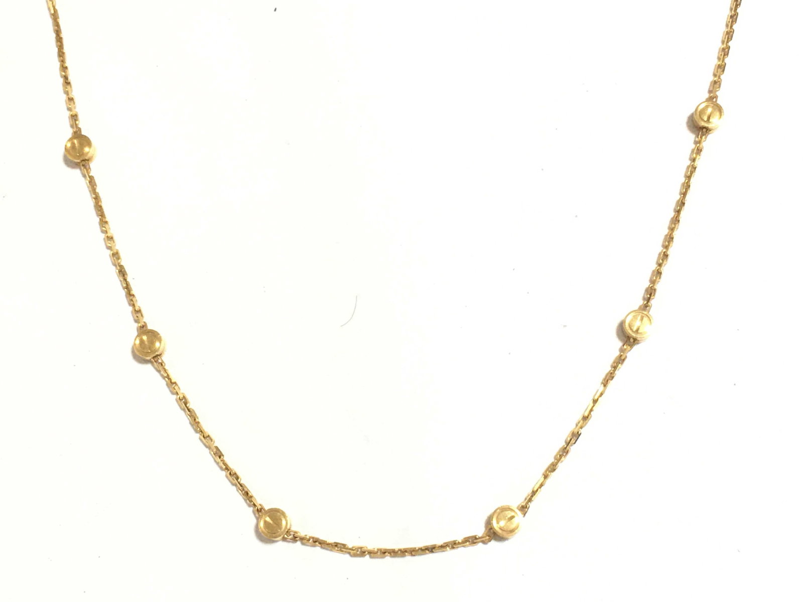 Cartier Love Screws Station Bezel Chain 18K Yellow Gold Necklace: Description: Cartier Love necklace crafted in 18K yellow gold and featuring the collection's iconic screw motifs arranged along a delicate chain design. The necklace is accented with bezel set element
