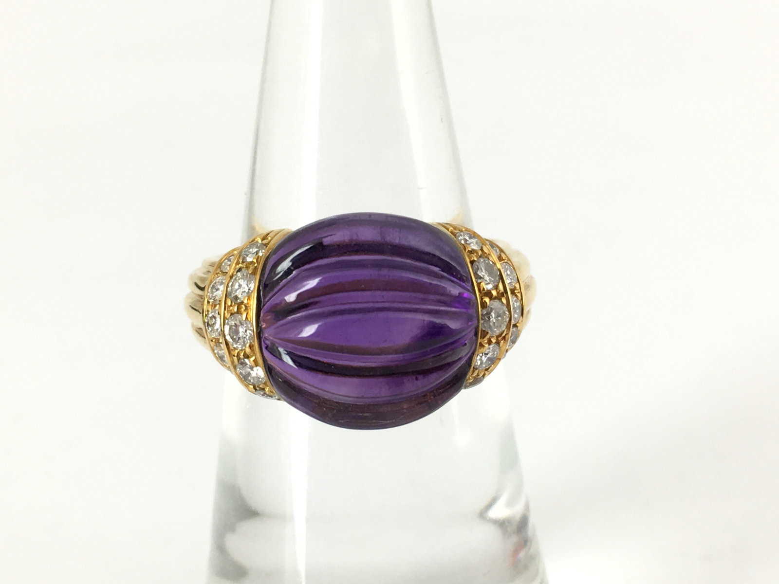 Boucheron Amethyst Diamond 18K Yellow Gold Vintage Ring: Description: This elegant Boucheron ring is crafted in solid 18K yellow gold and features a richly colored amethyst accented by brilliant natural diamonds in a refined sculptural design. The bold comp
