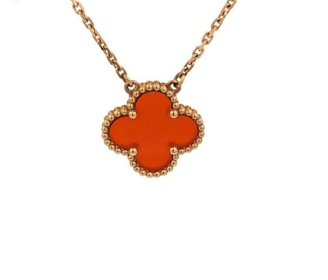 Van Cleef & Arpels Vintage Alhambra Red Carnelian 18K Yellow Gold Pendant Necklace: Description: Van Cleef & Arpels Vintage Alhambra pendant necklace crafted in 18K yellow gold and set with a vibrant natural red carnelian motif. Featuring the Maison's iconic clover design and sig
