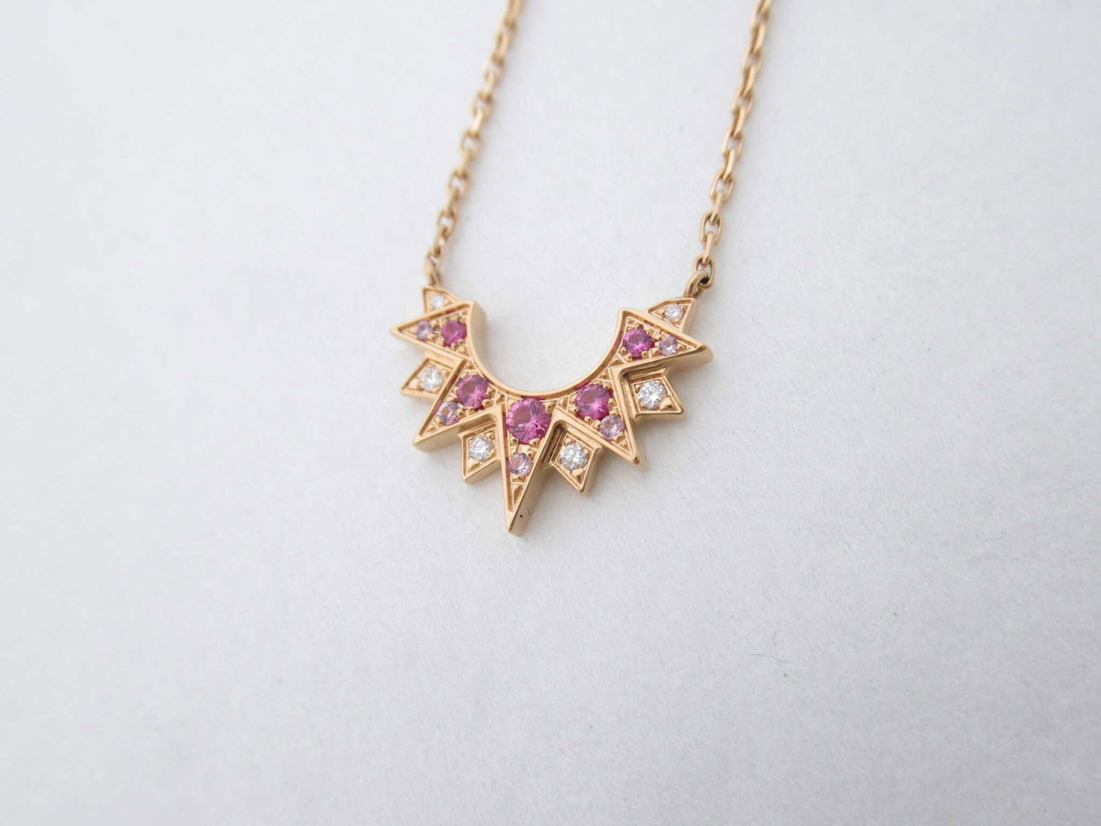 Piaget Sunlight Ruby Diamond 18K Rose Gold Japan Limited Necklace: Description: An elegant Piaget Sunlight necklace crafted in solid 18K rose gold and set with vibrant rubies and brilliant diamonds. The radiant sunburst design reflects Piaget’s refined
