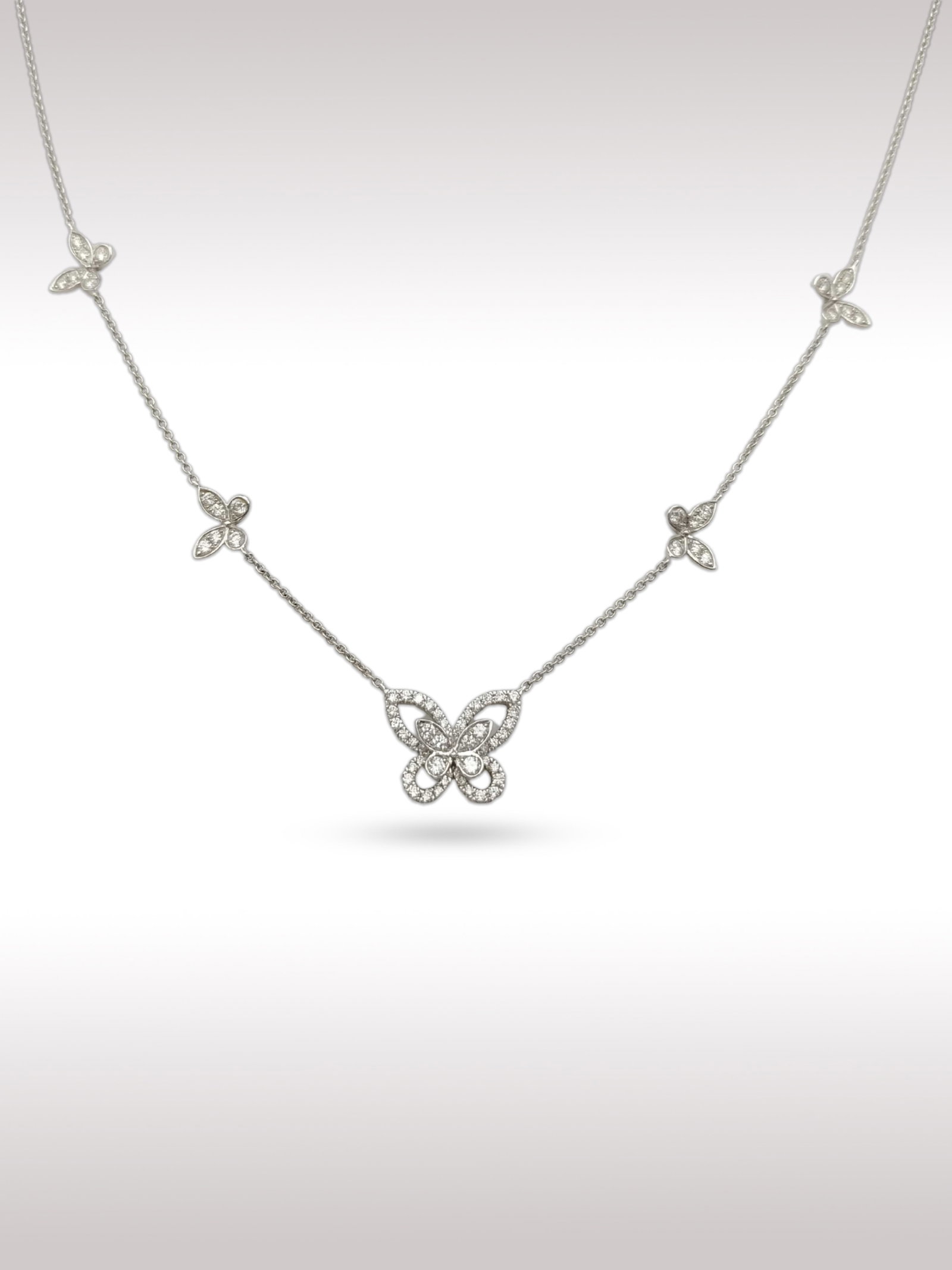 Graff Butterfly Diamond 18K White Gold Station Necklace: Description: Elegant Graff Butterfly station necklace crafted in 18K white gold, featuring a central butterfly motif fully set with brilliant cut diamonds. The delicate chain is accented with