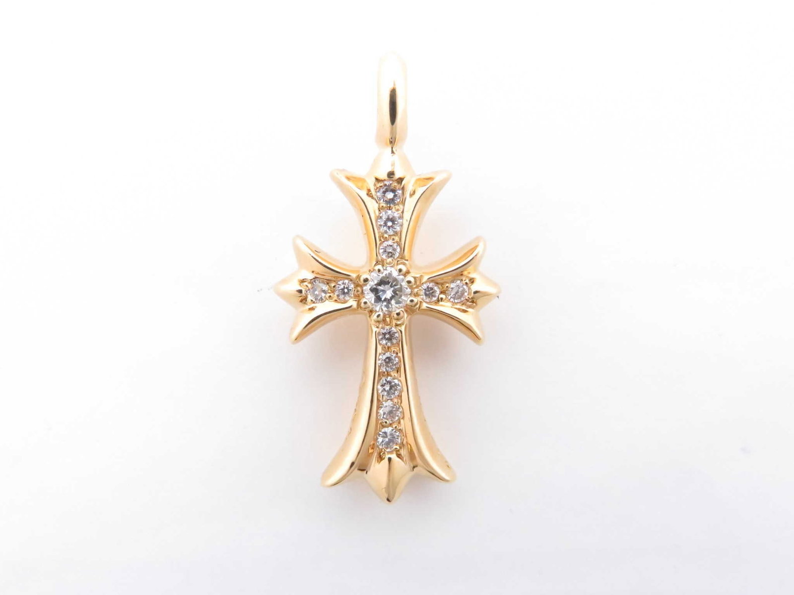 Chrome Hearts Tiny Fat Cross Pave Diamond Gold Pendant: Description: Iconic Chrome Hearts Tiny Fat Cross pendant crafted in solid gold, featuring the brand’s signature gothic cross silhouette set with pave diamonds. The sculptural form and precise