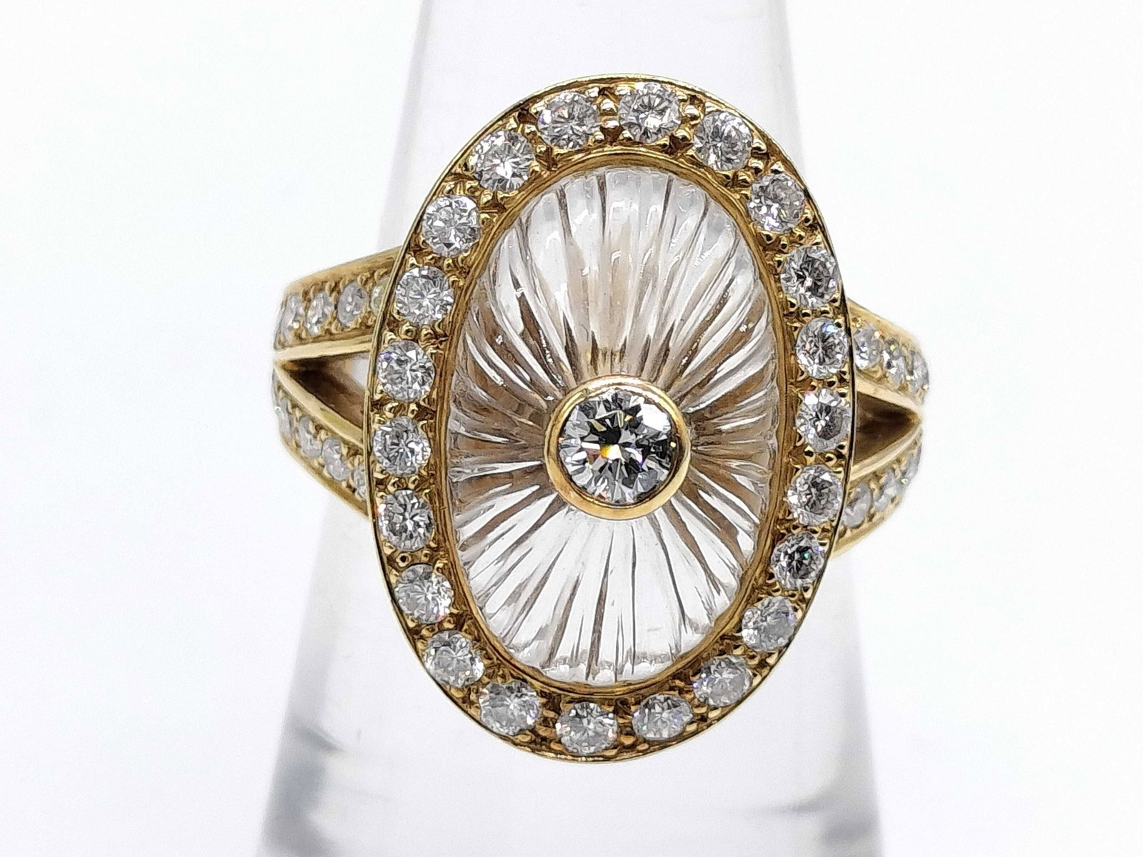 Boucheron Rock Crystal Diamond 18K Yellow Gold Ring: Description: This elegant Boucheron Rock Crystal ring is crafted in solid 18K yellow gold and features a beautifully carved rock crystal center accented by brilliant diamonds in a refined halo design.
