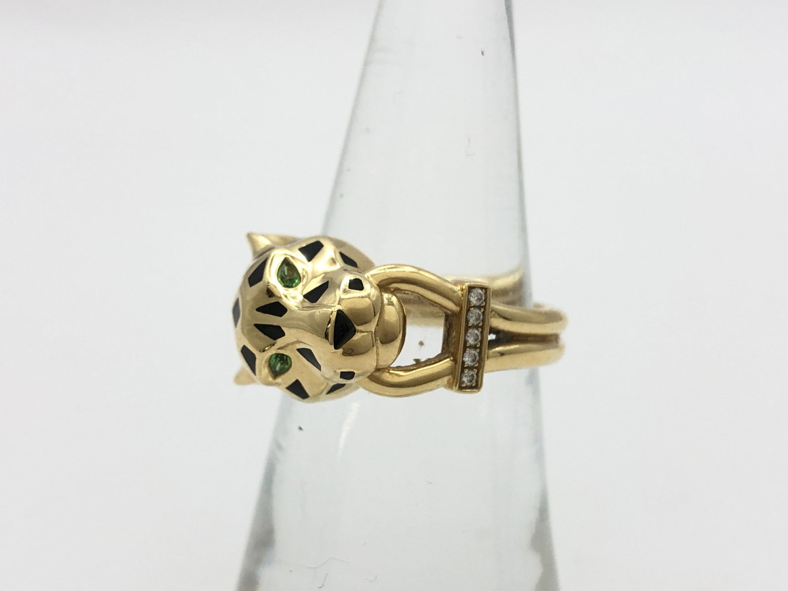Cartier Panthere Diamond Emerald Black Lacquer 18K Yellow Gold Vintage Ring: Description: Iconic Cartier Panthere ring crafted in 18K yellow gold, featuring the Maison signature sculptural panther head design adorned with vivid emerald eyes and bold black lacquer detailing. Th