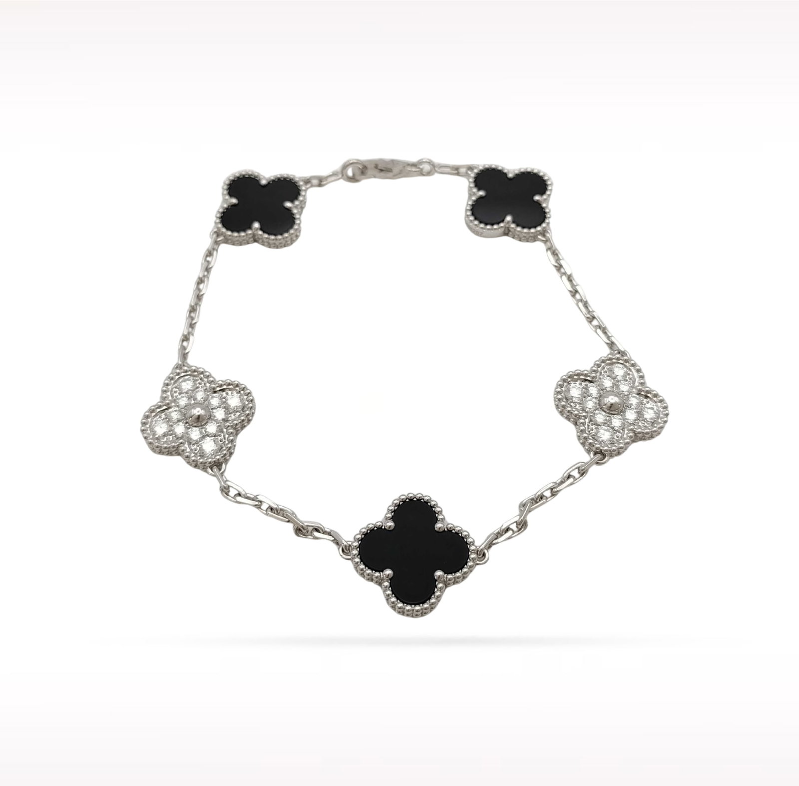 Van Cleef & Arpels Vintage Alhambra Black Onyx Diamond 18K White Gold 5 Motif Bracelet: Description: Van Cleef & Arpels Alhambra 5 Motif bracelet crafted in 18K white gold and accented with natural black onyx and brilliant diamonds. From the iconic Alhambra collection, this elegant b
