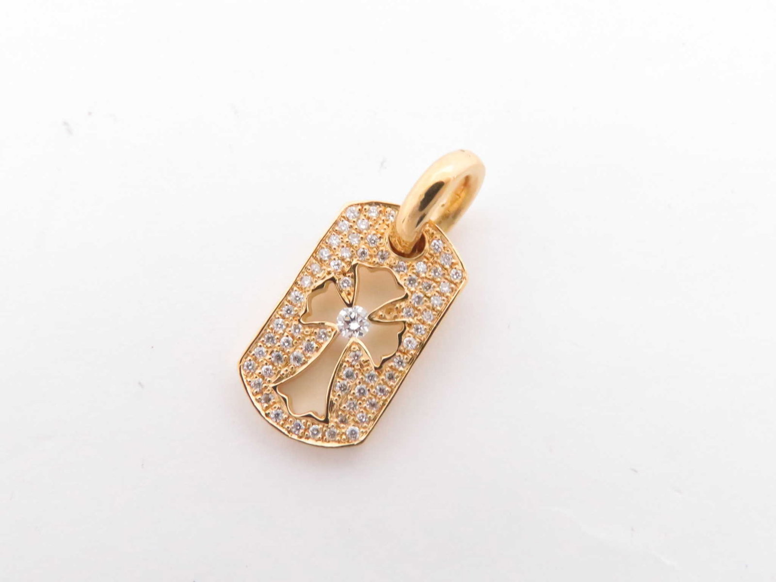 Chrome Hearts Dog Tag Cut Out Cross Diamond Pendant: Description: Distinctive Chrome Hearts dog tag pendant top crafted in solid gold, featuring the brand’s iconic cut out cross motif accented with brilliant diamonds. The dog tag silhouette combin