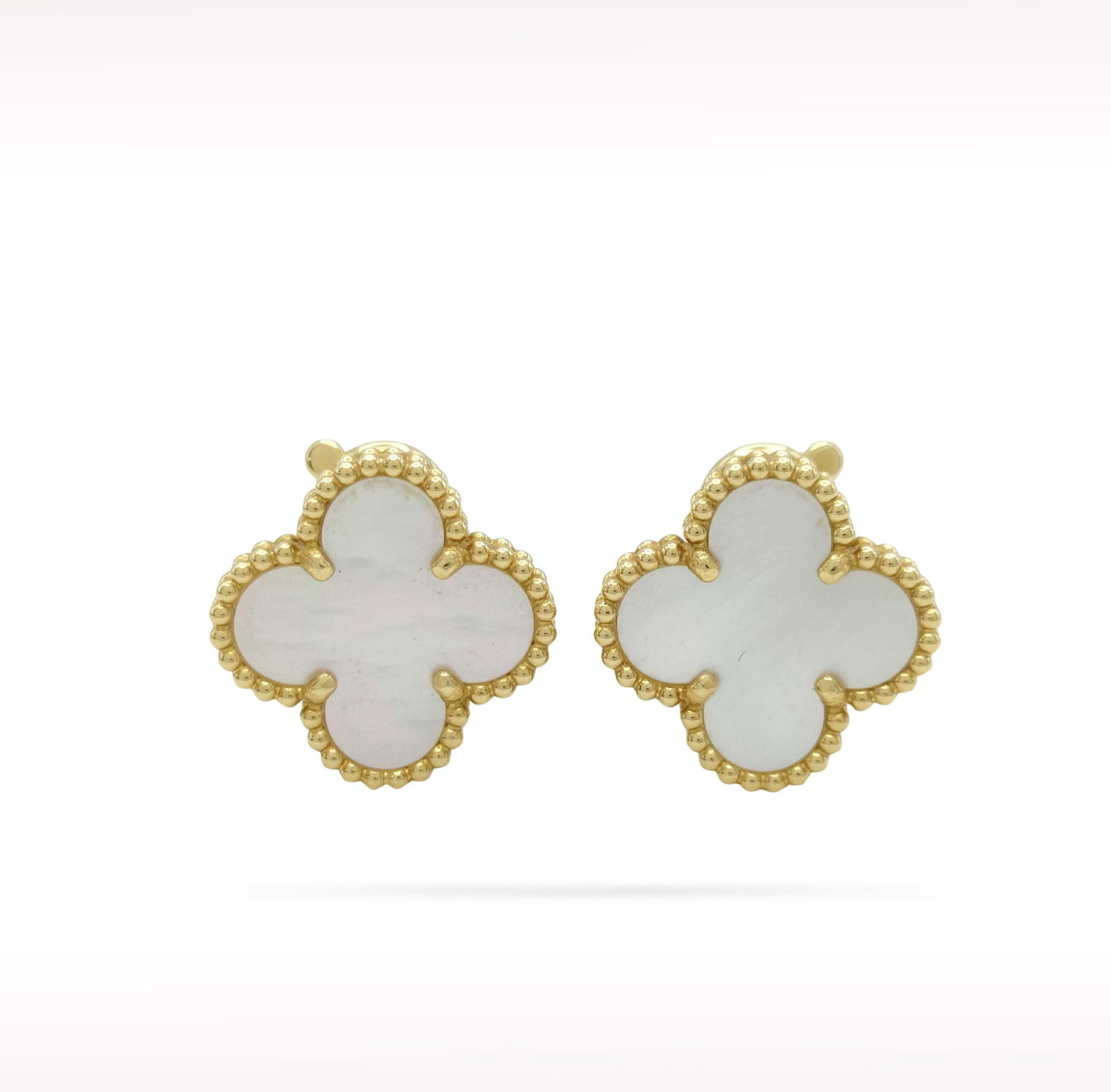Van Cleef & Arpels Vintage Alhambra White Mother of Pearl 18K Yellow Gold Earrings: Description: Van Cleef & Arpels Vintage Alhambra clip earrings crafted in 18K yellow gold and accented with natural white mother of pearl. From the iconic Vintage Alhambra collection, these elegan