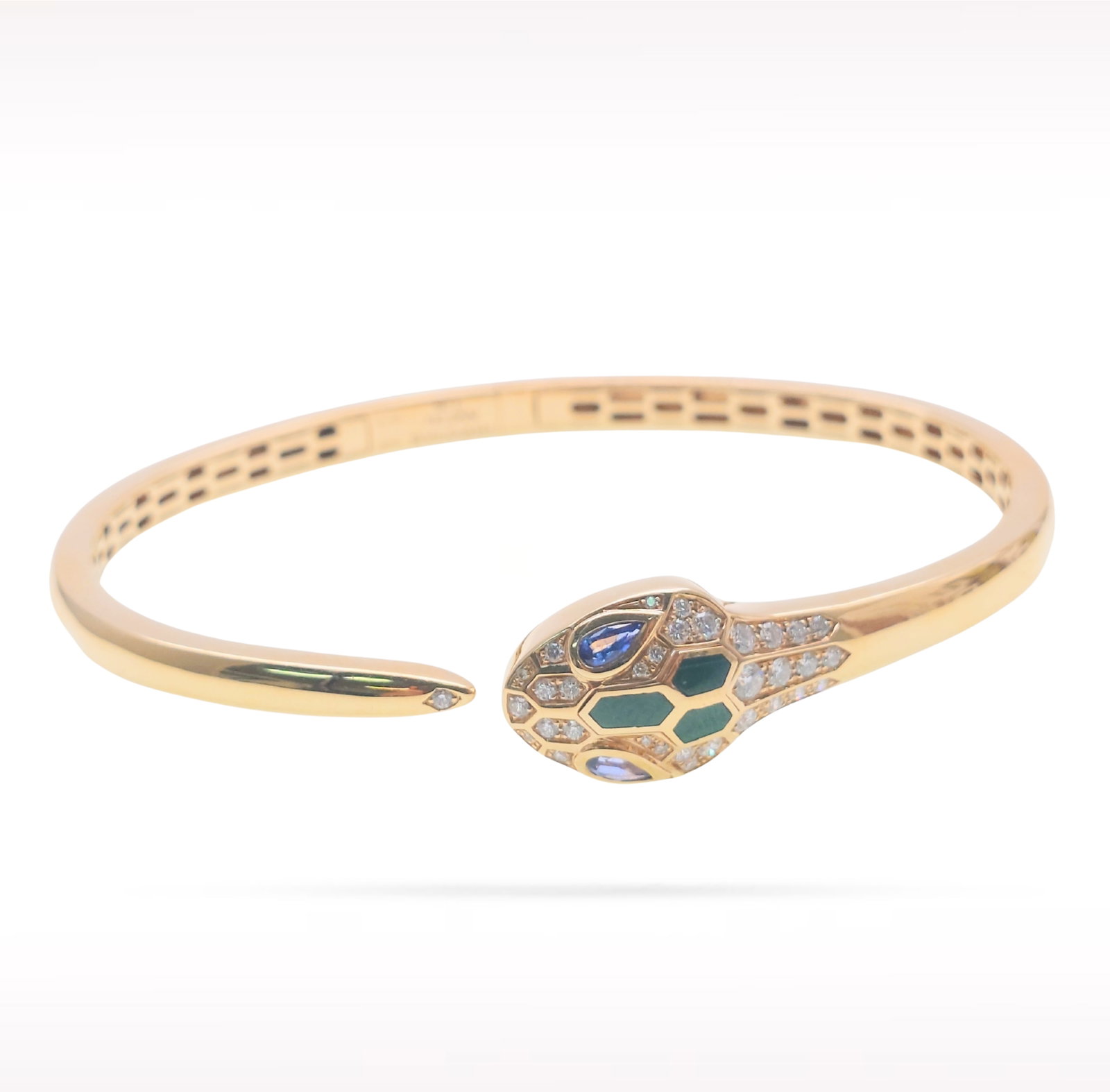 Bvlgari Serpenti Seduttori Malachite Sapphire Half Pave Diamond 18K Rose Gold Bangle Bracelet: Description: Bvlgari Serpenti Seduttori bangle bracelet crafted in 18K rose gold and accented with natural half pave set diamonds, malachite, and blue sapphires. From the iconic Serpenti Seduttori col