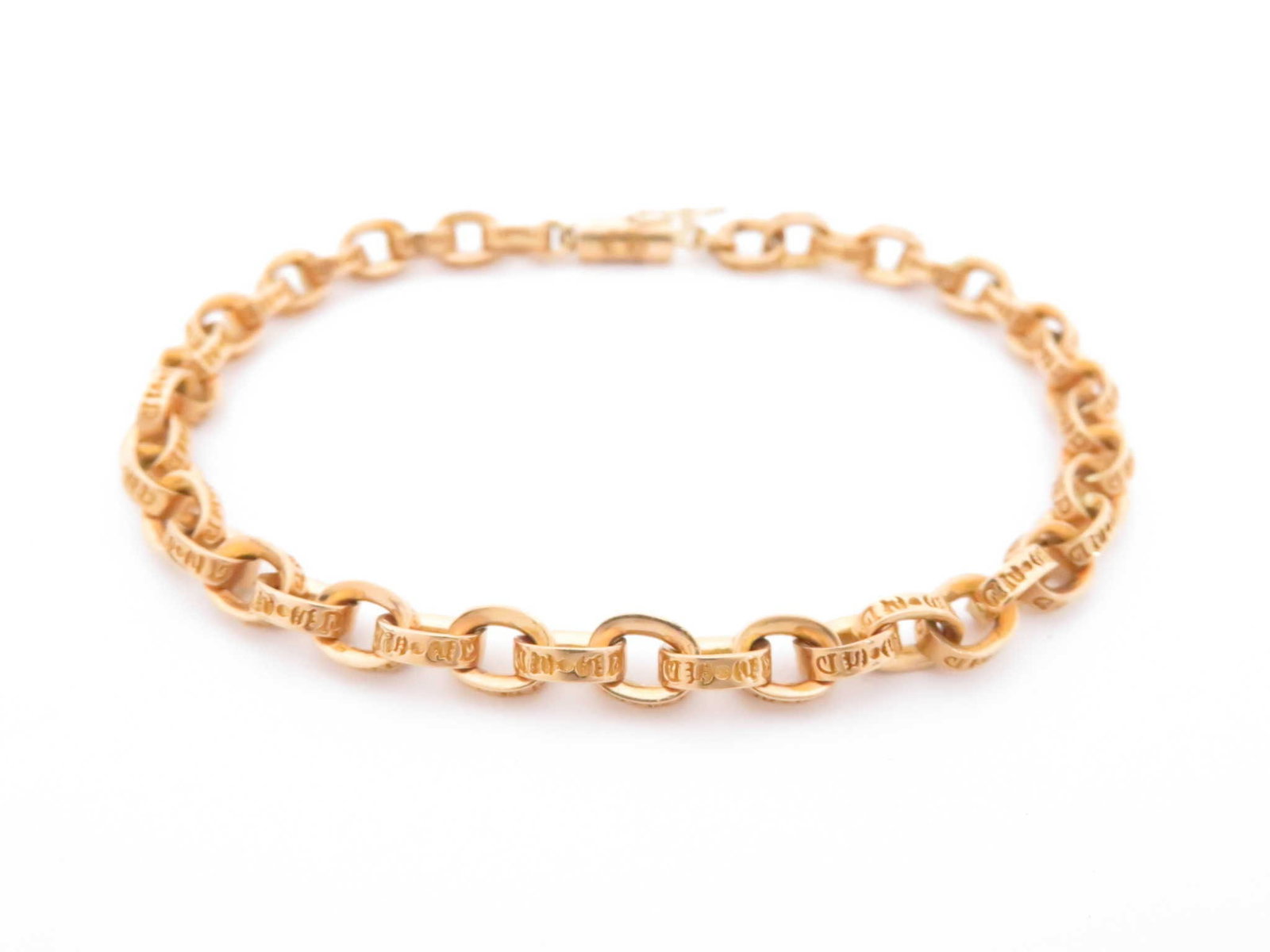 Chrome Hearts Gold Paper Scrolled Cable Link Chain Bracelet: Description: Iconic Chrome Hearts paper chain bracelet crafted in solid gold, featuring the brand’s signature interlocking elongated links with engraved detailing throughout. The bold yet refine