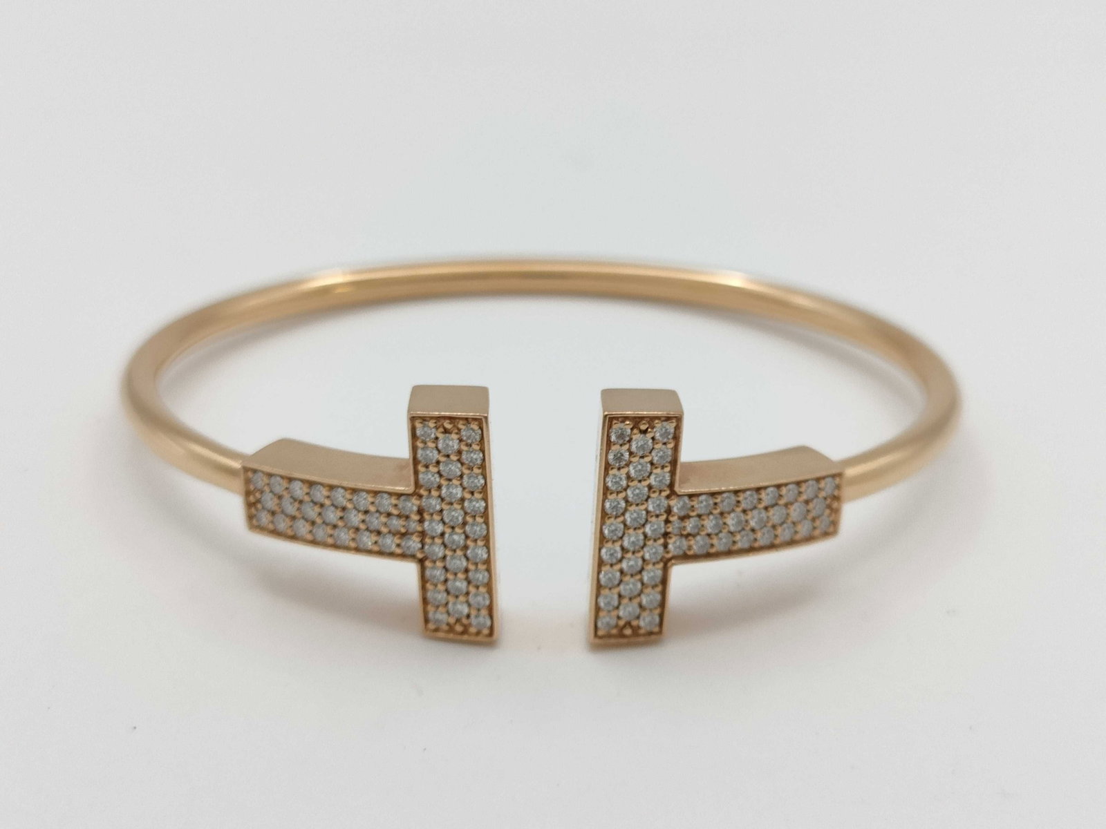 Tiffany & Co. Large T Wire Pave Diamond 18K Rose Gold Bangle Bracelet: Description: Tiffany & Co. T Wire bangle bracelet crafted in 18K rose gold and accented with pave set natural diamonds totaling approximately 0.67 carats. Featuring the collection's iconic T motif