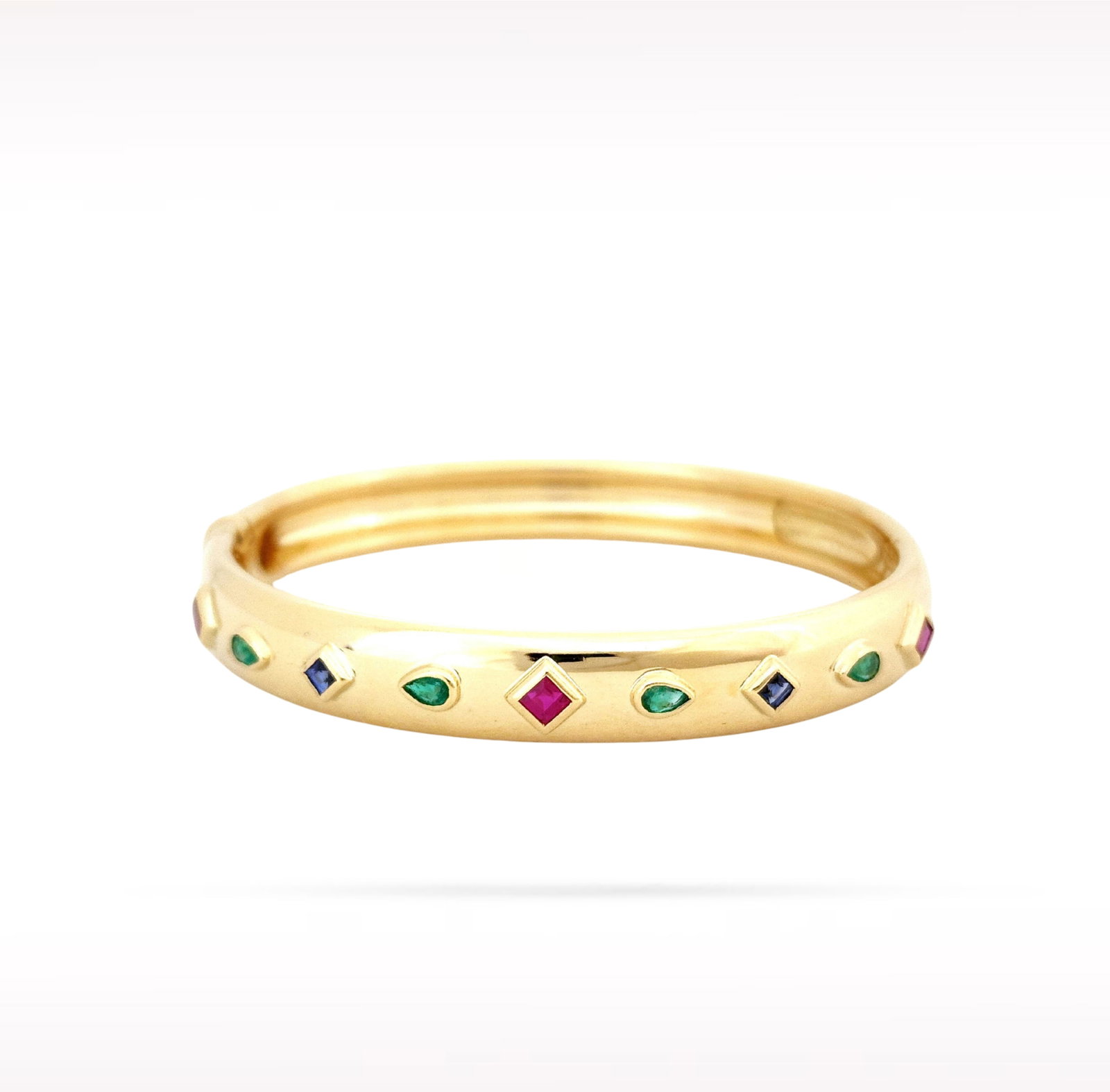 Cartier Byzantine Ruby Sapphire Emerald Diamond 18K Yellow Gold Bangle Bracelet: Description: Cartier Byzantine bangle bracelet crafted in 18K yellow gold and accented with natural diamonds, rubies, sapphires, and emeralds. Inspired by the rich artistry of Byzantine design, this e
