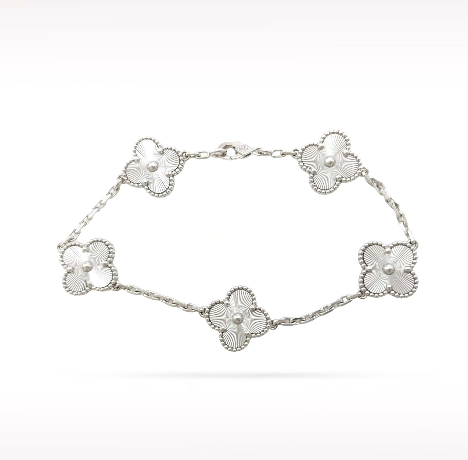 Van Cleef & Arpels Vintage Alhambra Guilloche 18K White Gold 5 Motif Bracelet: Description: Van Cleef & Arpels Vintage Alhambra 5 Motif bracelet crafted in 18K white gold and featuring exquisite guilloche motifs. From the iconic Vintage Alhambra collection, this elegant brac