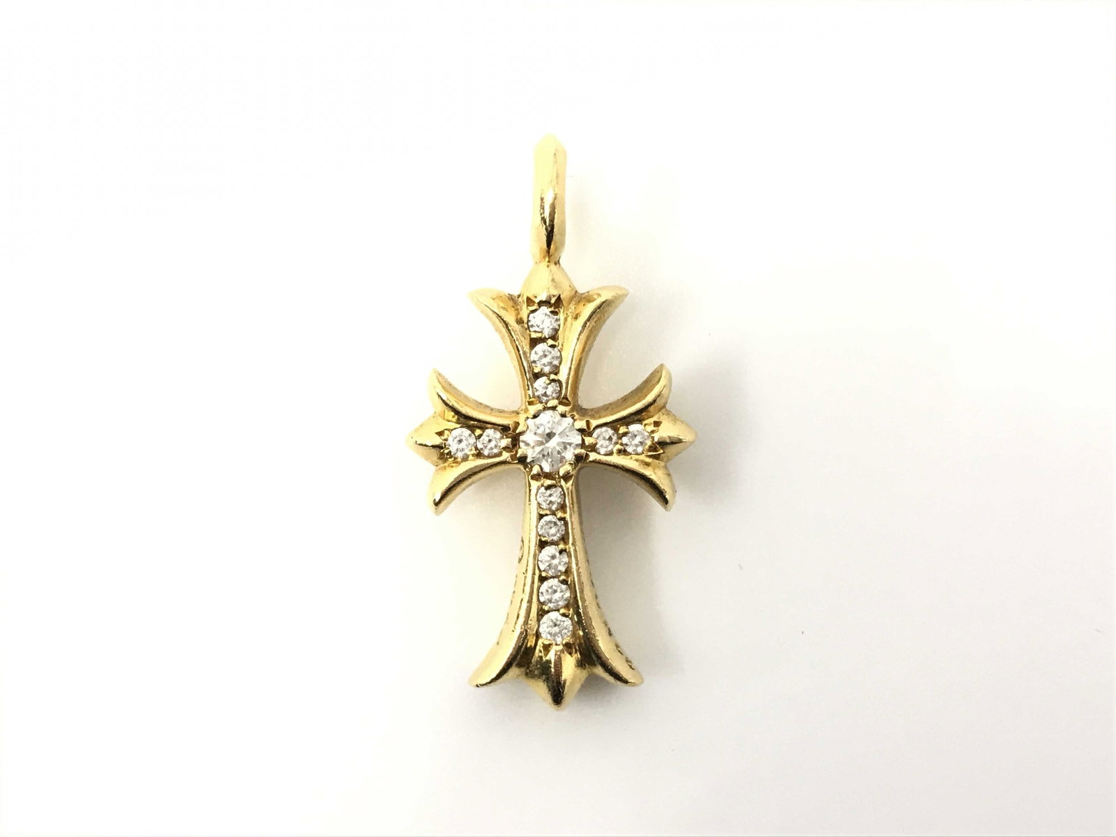 Chrome Hearts Fat Cross Pave Diamond 22K Gold Charm Pendant: Description: Distinctive Tiny Fat cross charm pendant crafted in solid gold, showcasing Chrome Hearts’ iconic cross motif enhanced with brilliant pave-set diamonds across the center and arms. Th