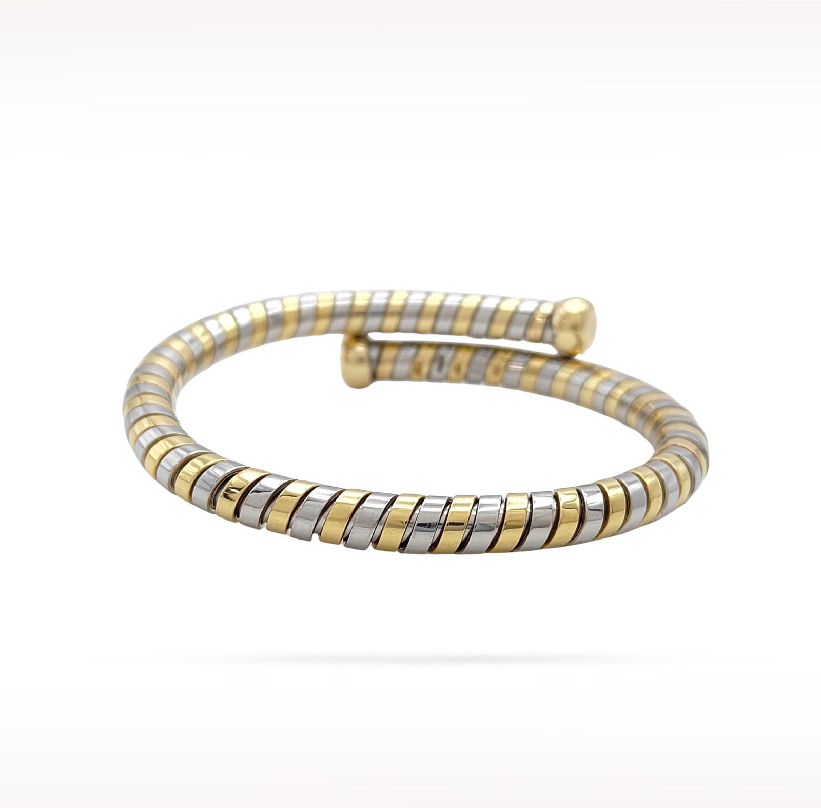 Bvlgari Tubogas 18K Yellow Gold Stainless Steel Bangle Bracelet: Description: Bvlgari Tubogas bangle bracelet crafted in 18K yellow gold and stainless steel. From the iconic Tubogas collection, this elegant bracelet features the collection's signature flexible coil
