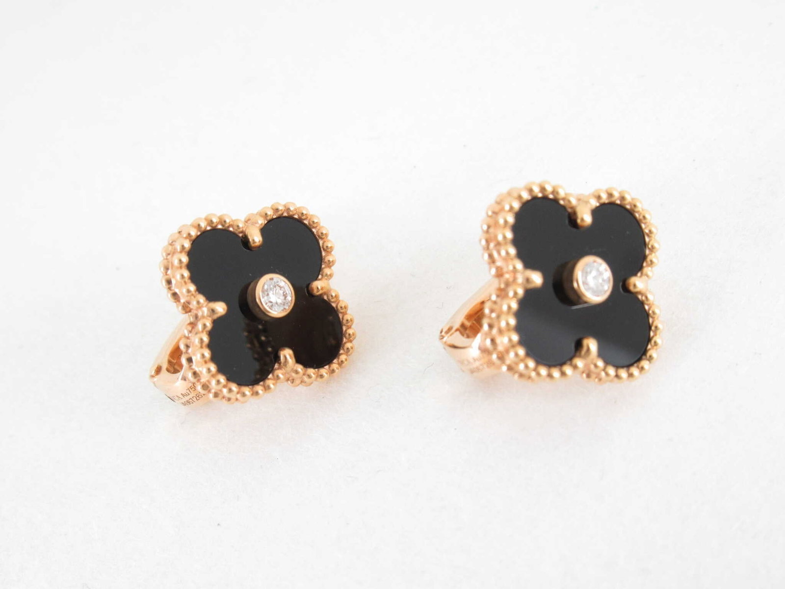 Van Cleef & Arpels Vintage Alhambra Black Onyx Diamond 18K Rose Gold Limited Edition Earrings: Description: Van Cleef & Arpels Vintage Alhambra earrings crafted in 18K rose gold and featuring the Maison's iconic clover motifs accented with black onyx and natural diamonds. Combining the stri